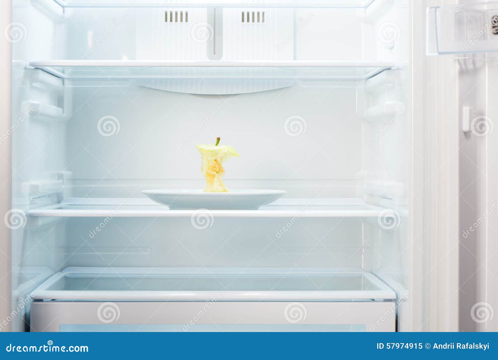 Apple Core on White Plate in Open Empty Refrigerator Stock Image