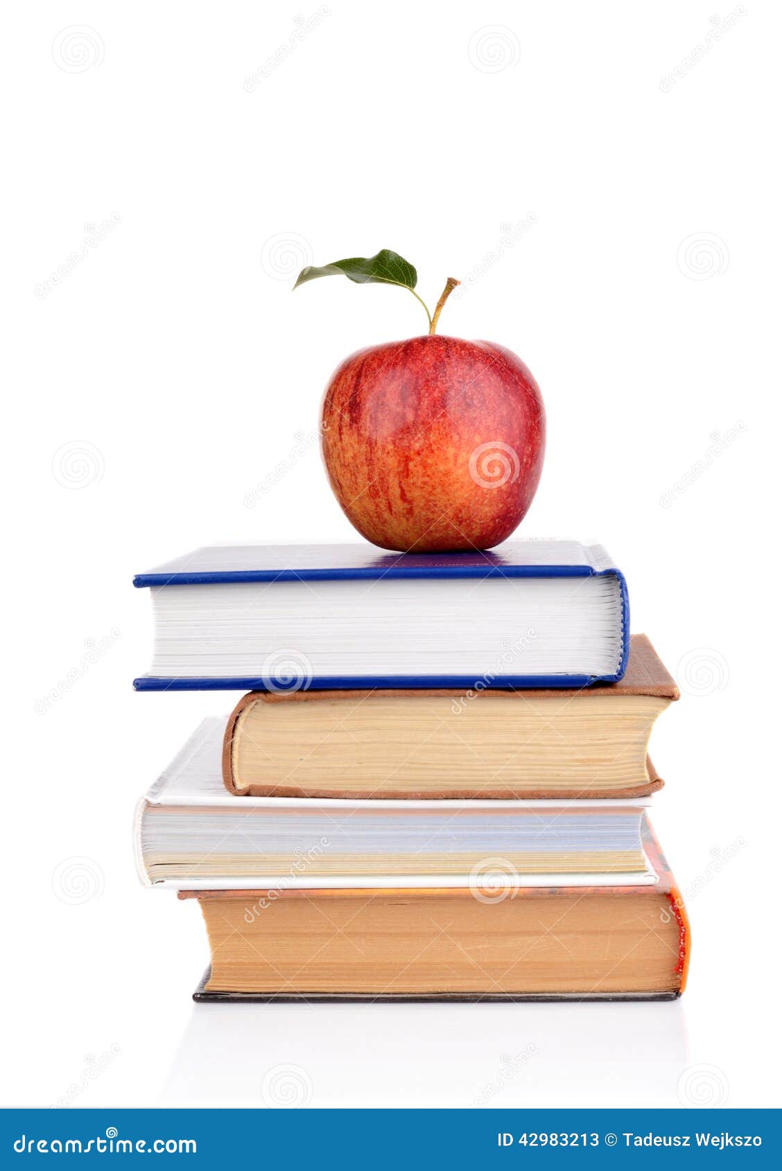 apple on few school books on a white background
