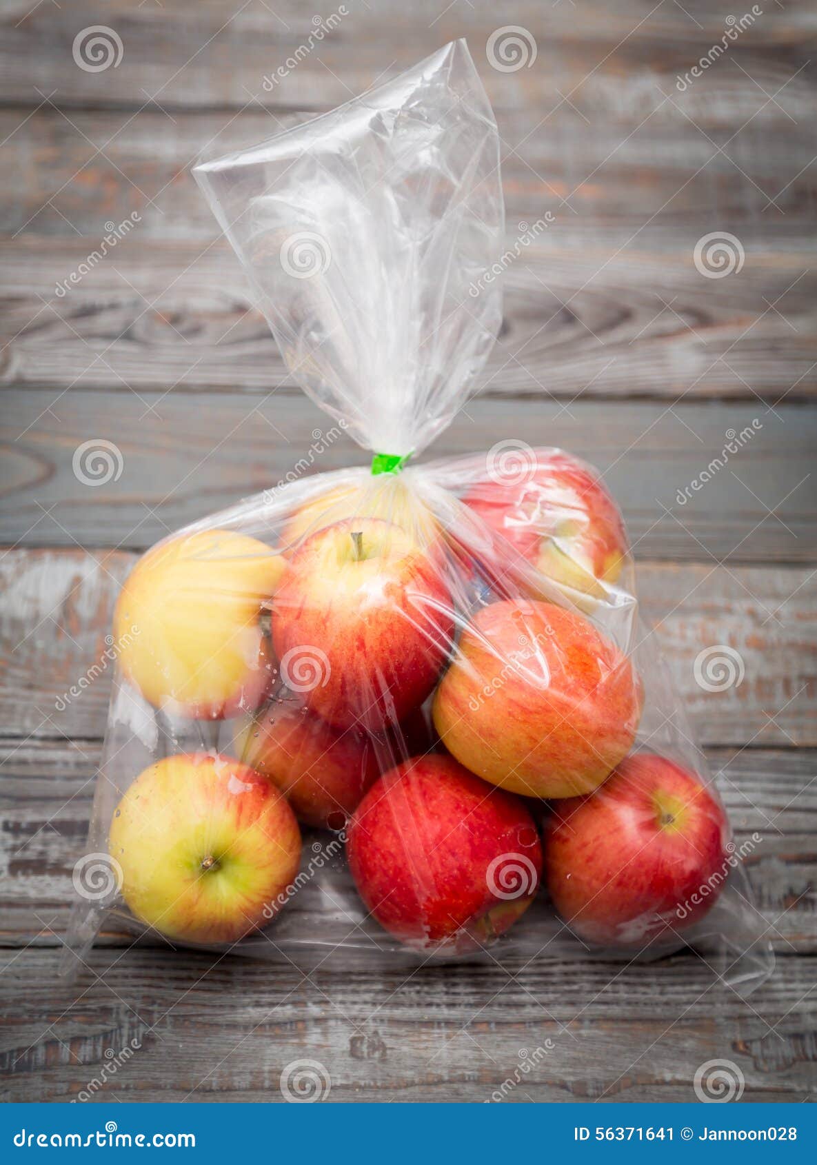 Yellow ripe apples in opened plastic bag on grey background. 17381861 Stock  Photo at Vecteezy