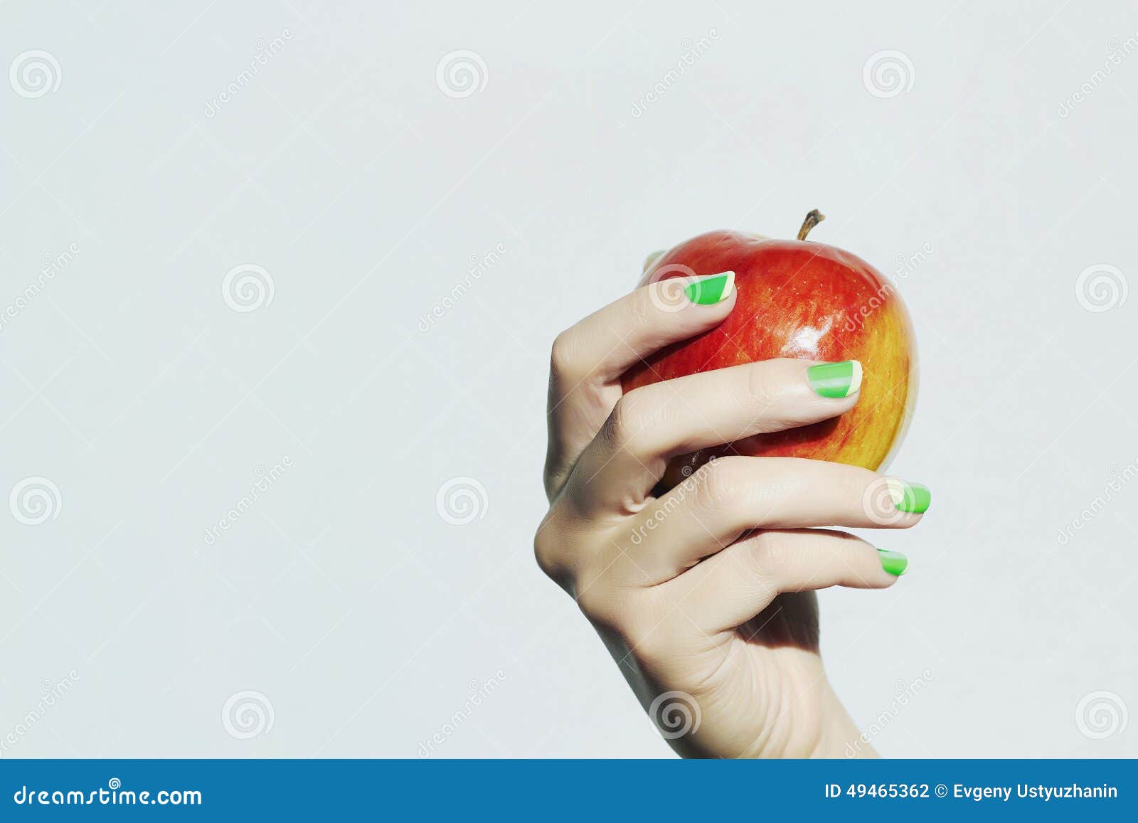 apple in hand with manicure.beauty salon woman shellac polish nail