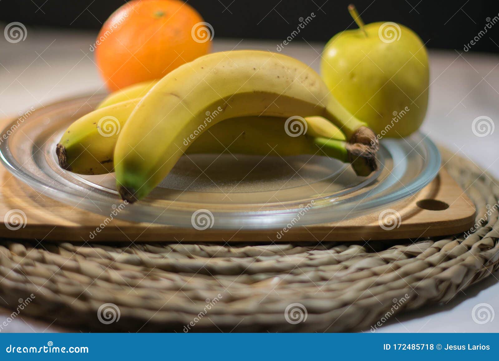apple and orange bananas on a glass tray for dessert