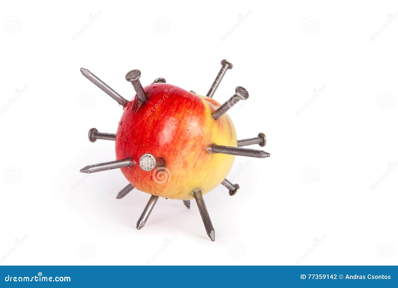 Apple stuck with iron nails. Apple stuck with lots of iron nails on white background
