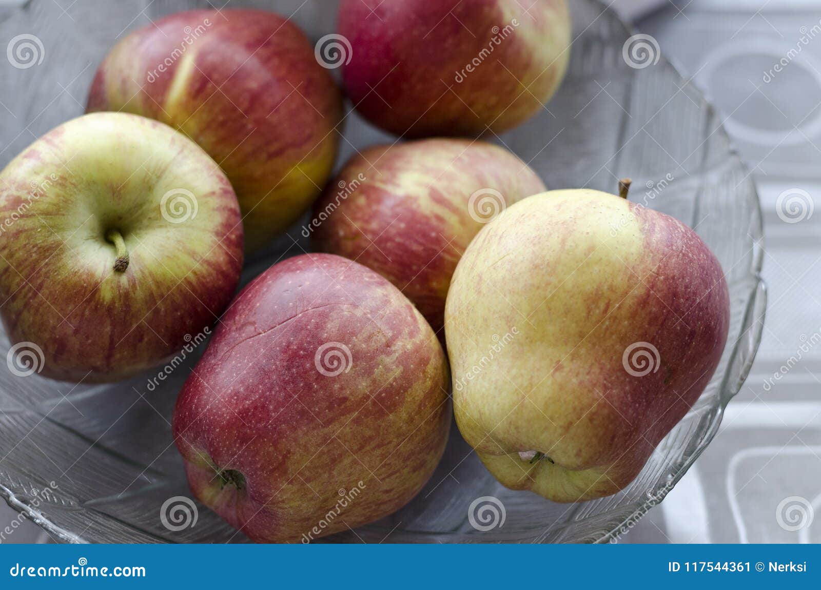 Apples in a glass plate stock image. Image of glass 117544361