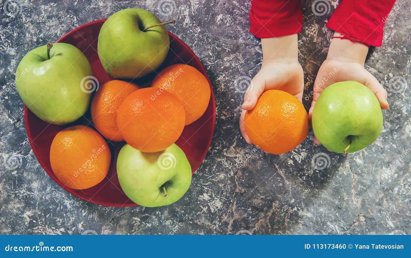 Apples and Oranges in the Hands of a Child. Stock Photo Image of baby, children 113173460