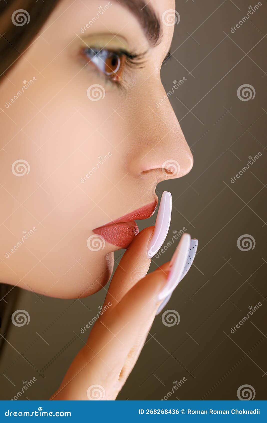 Applying Foundation with a Brush Around the Lip Contour after Permanent Makeup Stock Photo