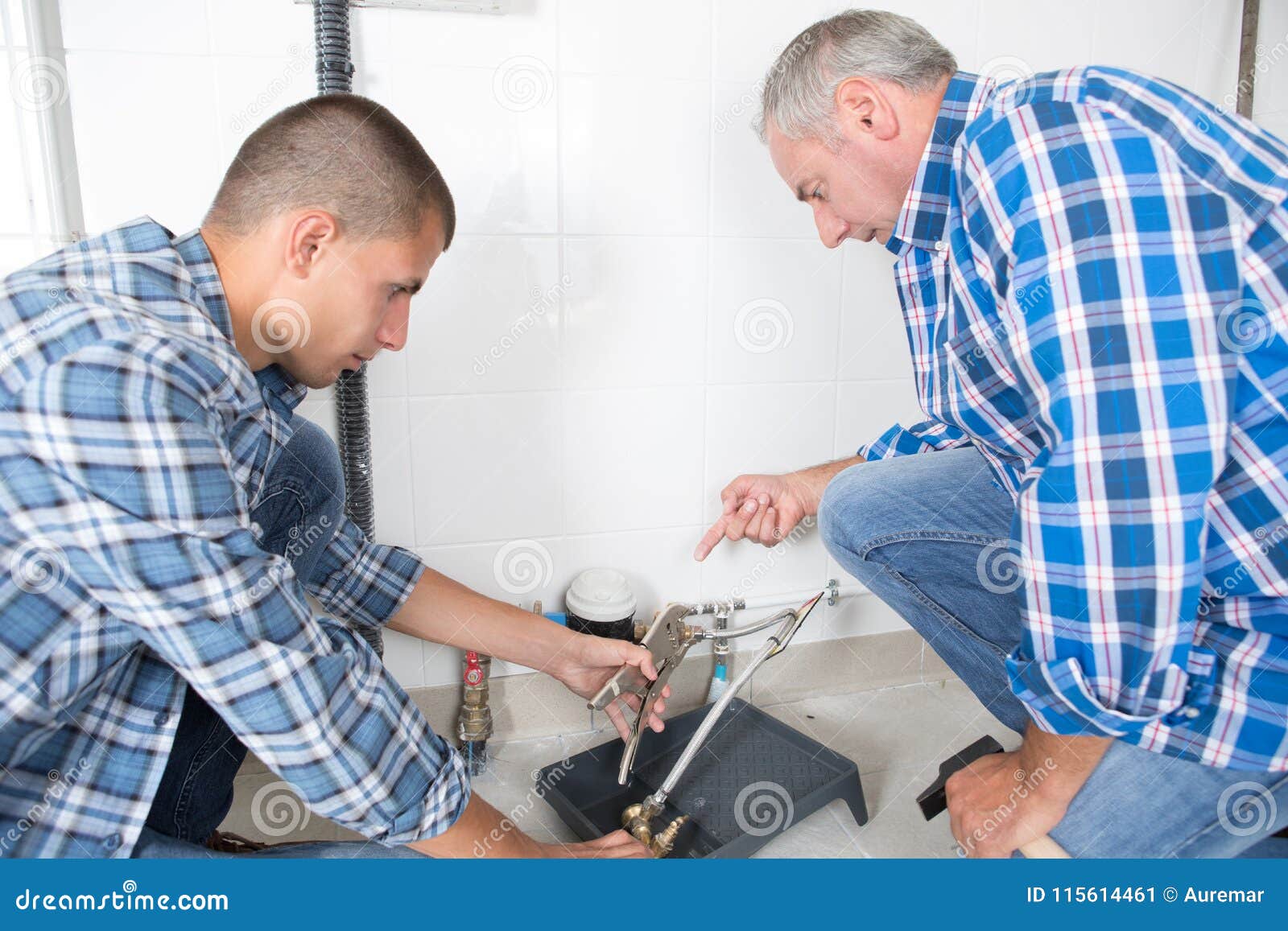 Apprentice cutting a tile stock image. Image of installation 115614461