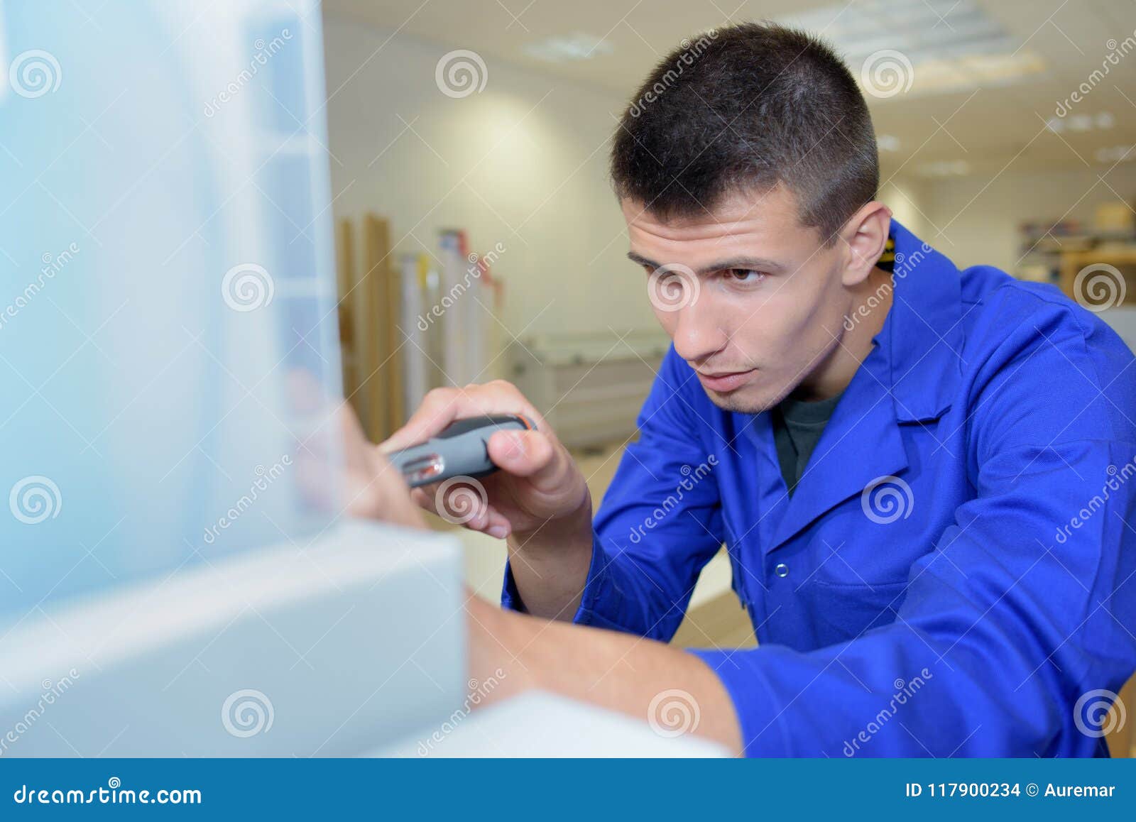 Apprentice with Spanner Working on Machine Part Stock Photo Image of