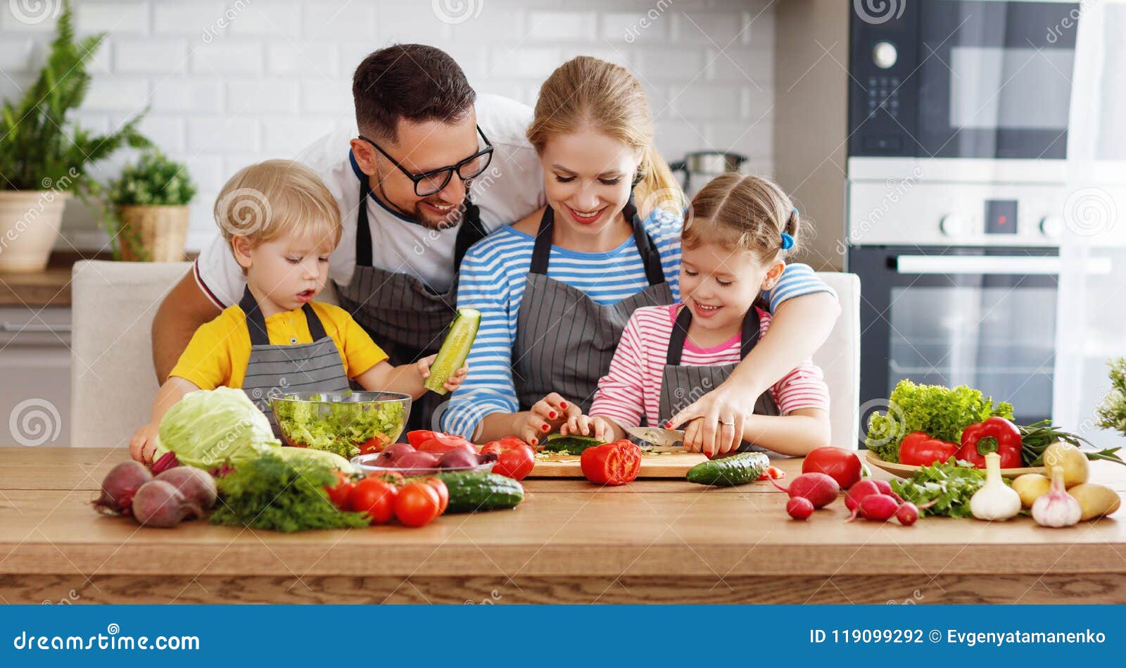 appy family with child preparing vegetable salad