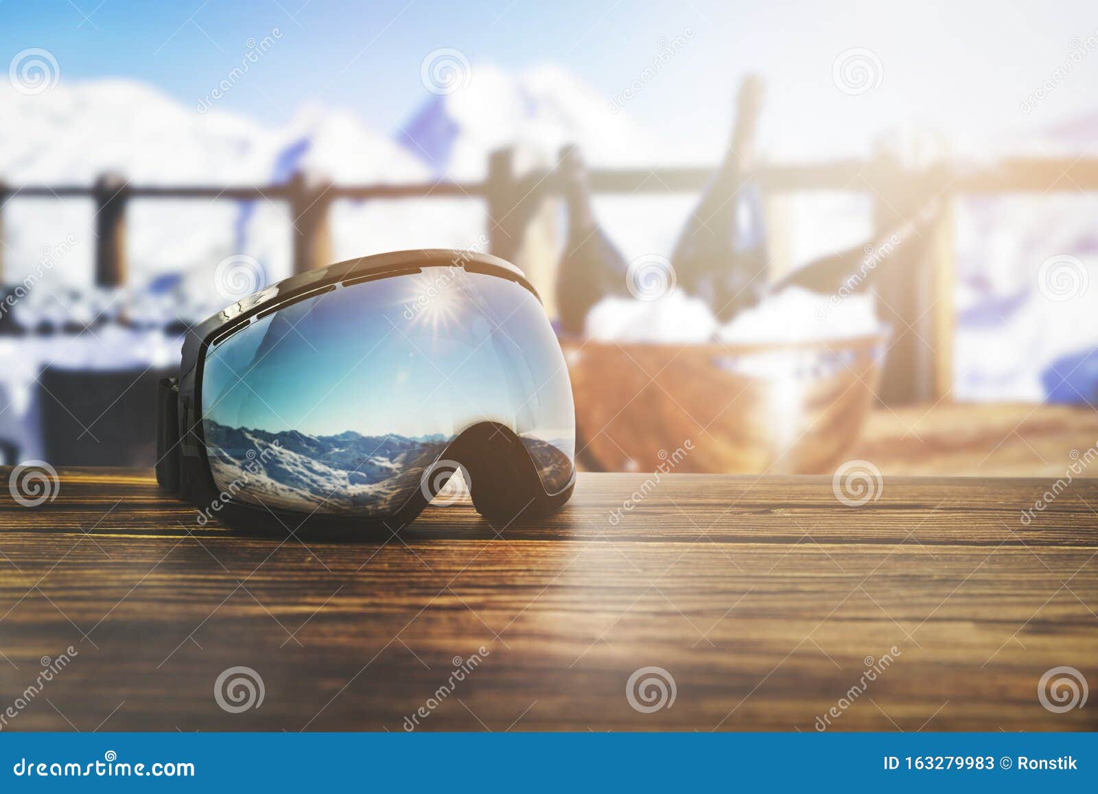 Apres Ski Goggles with Mountains Reflection on the Restaurant Table