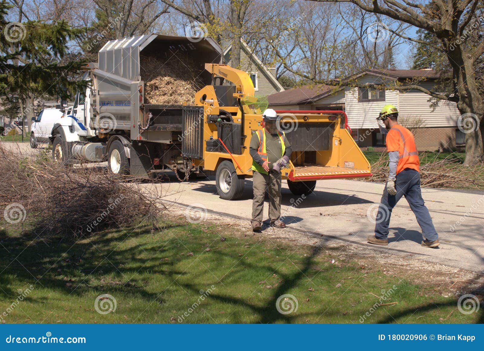City Workers Use a Wood Chipper To Conduct Brush Pickup, a Service