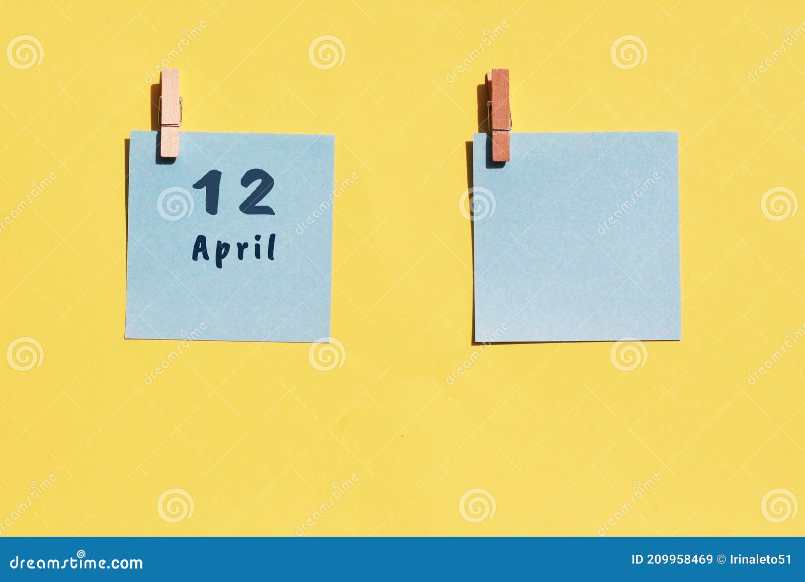 april 12st. day of 12 month, calendar date. two blue sheets for writing on a yellow background. top view, copy space. spring month
