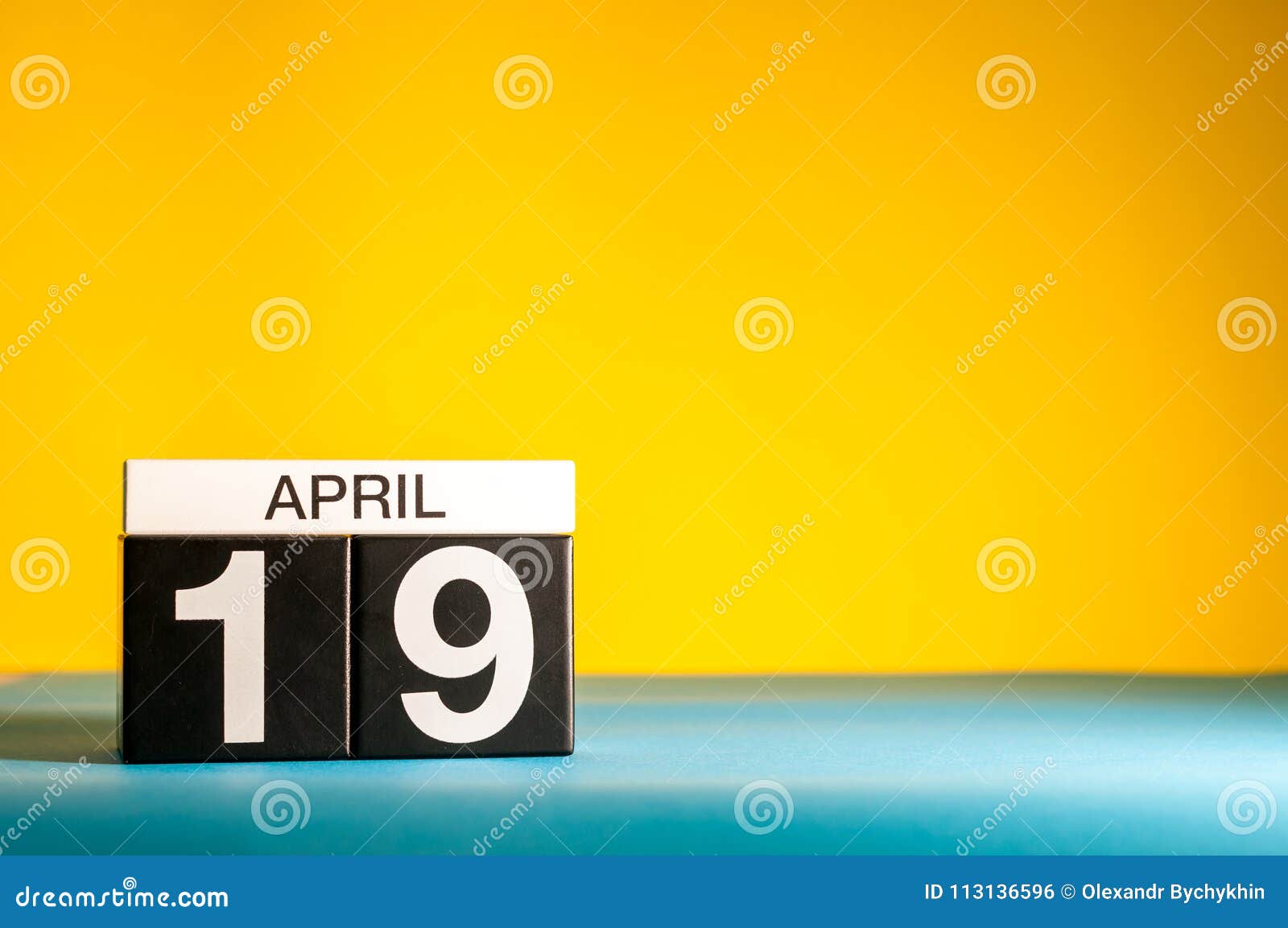 April 19th. Day 19 of April Month, Calendar on Table with Yellow