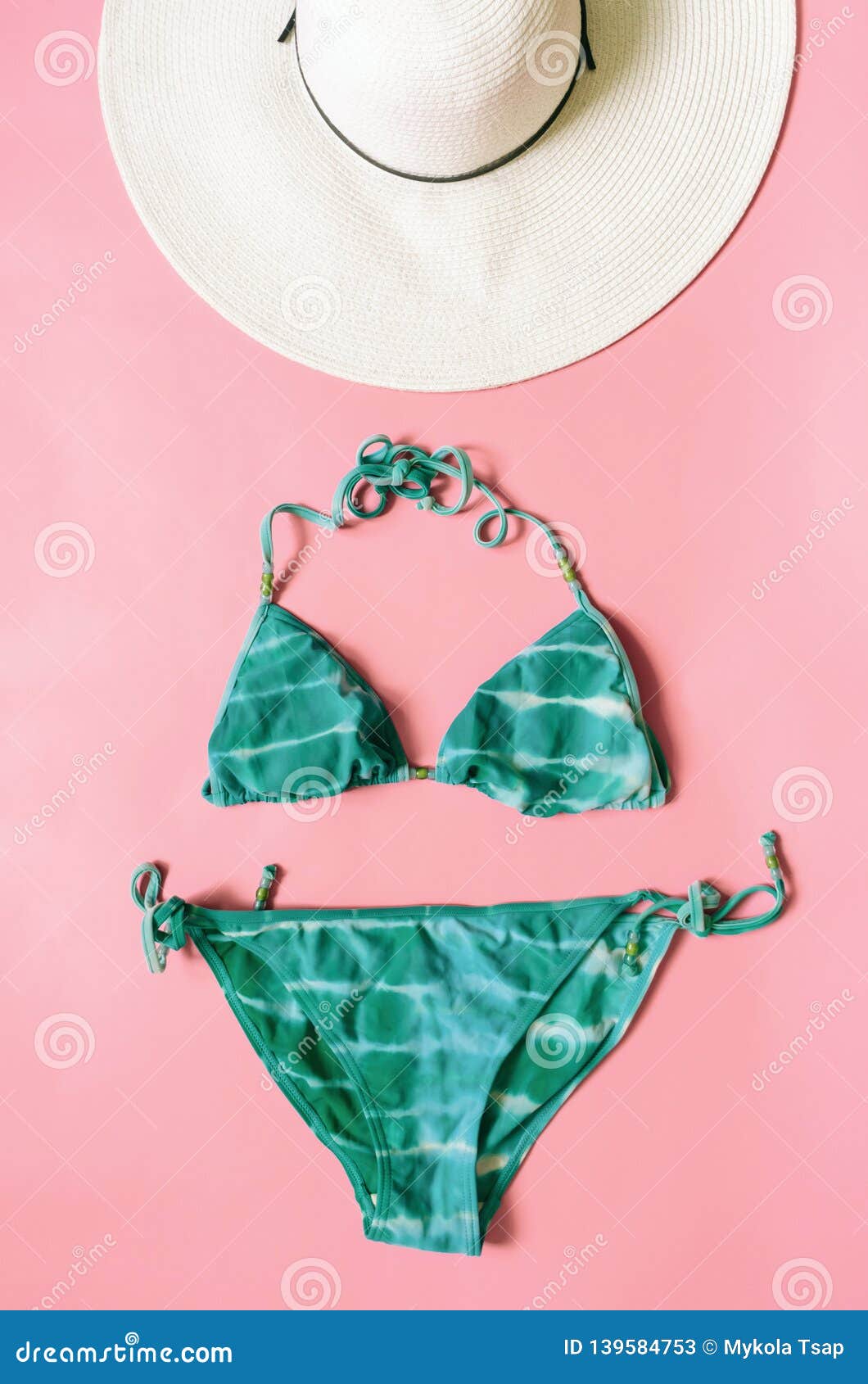 Aquamarine Bikini Swimsuit And Straw Hat Arranged On Light Pink ...