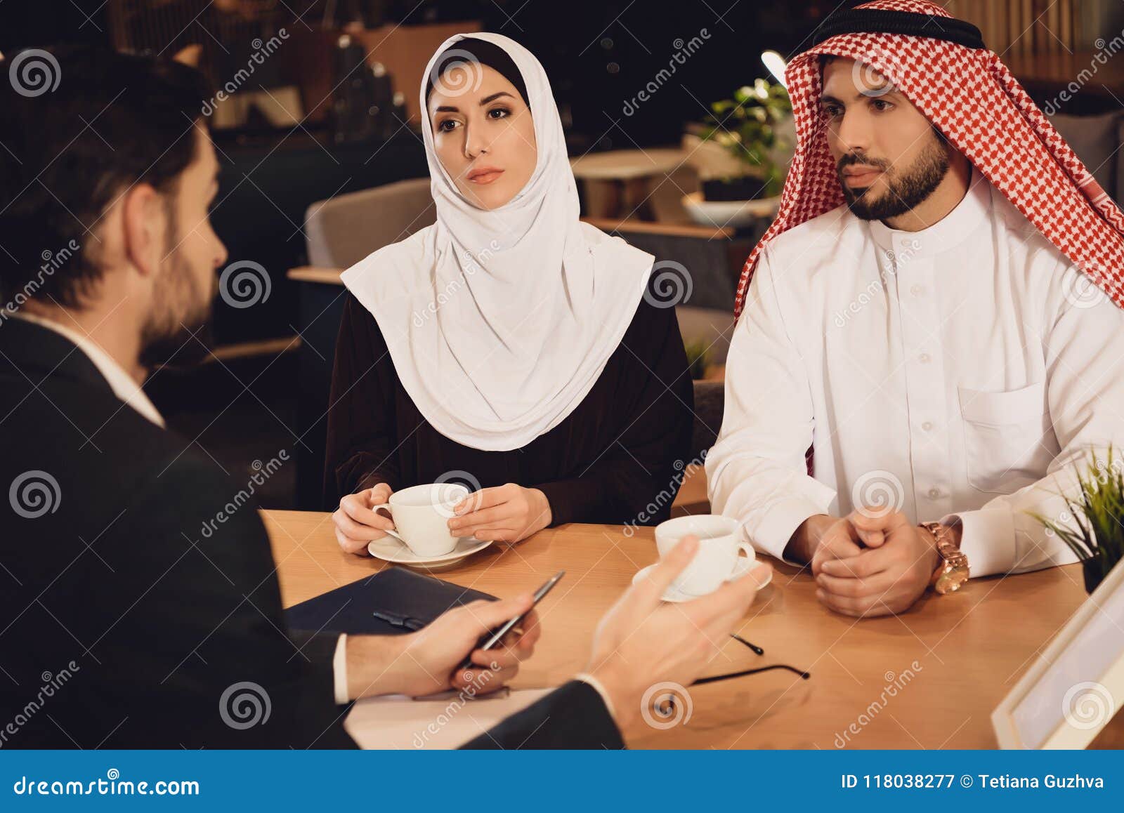 Arab Couple Drinks Coffee At Therapist Reception Stock I