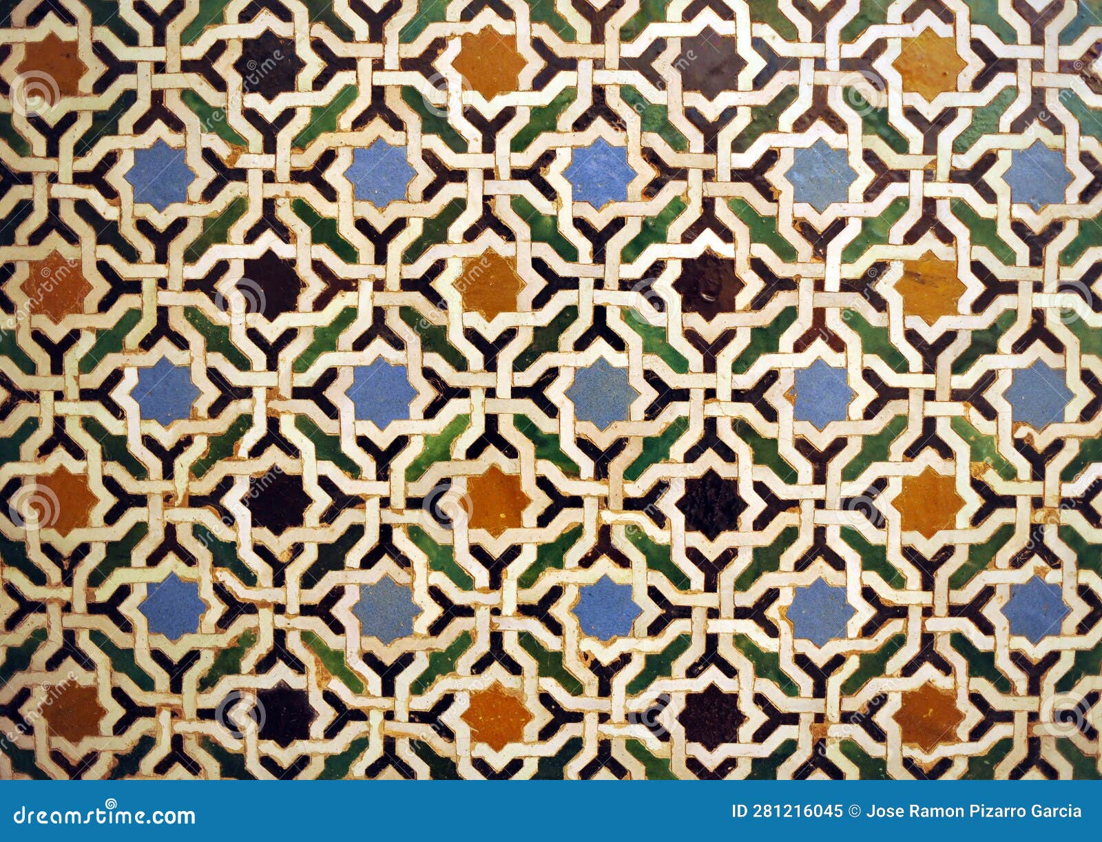 arab geometric mosaic of alhambra in granada, spain.