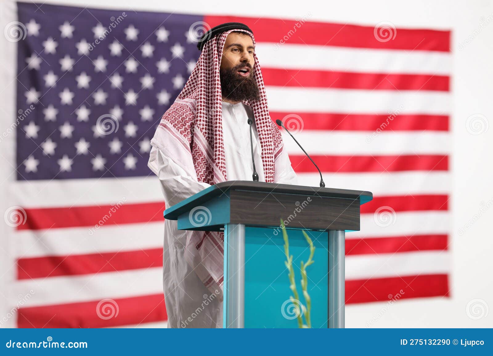 Arab Man Giving a Speech on a Pedestal in Front of USA Flag Stock Photo