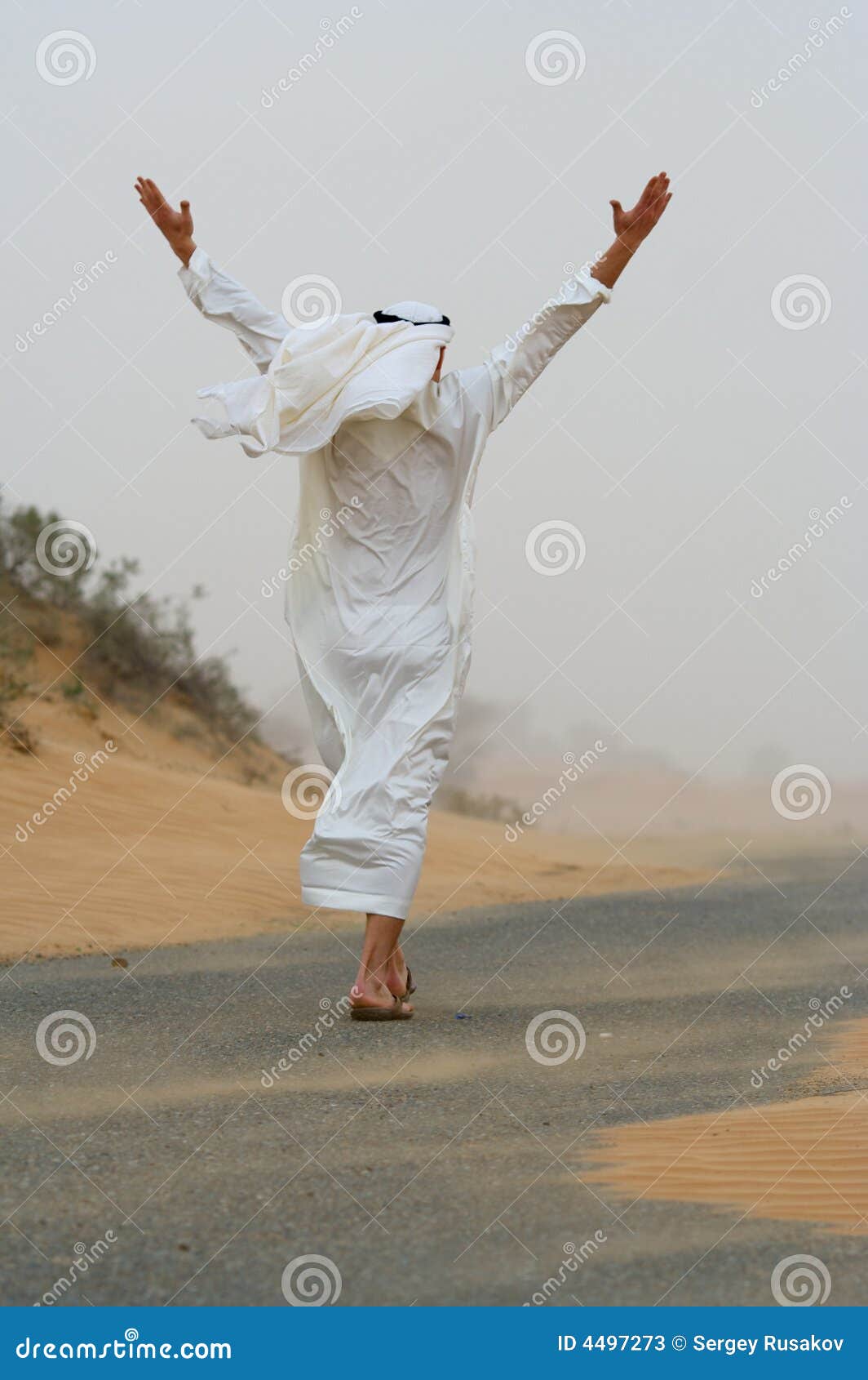 arab man walking in sand storm