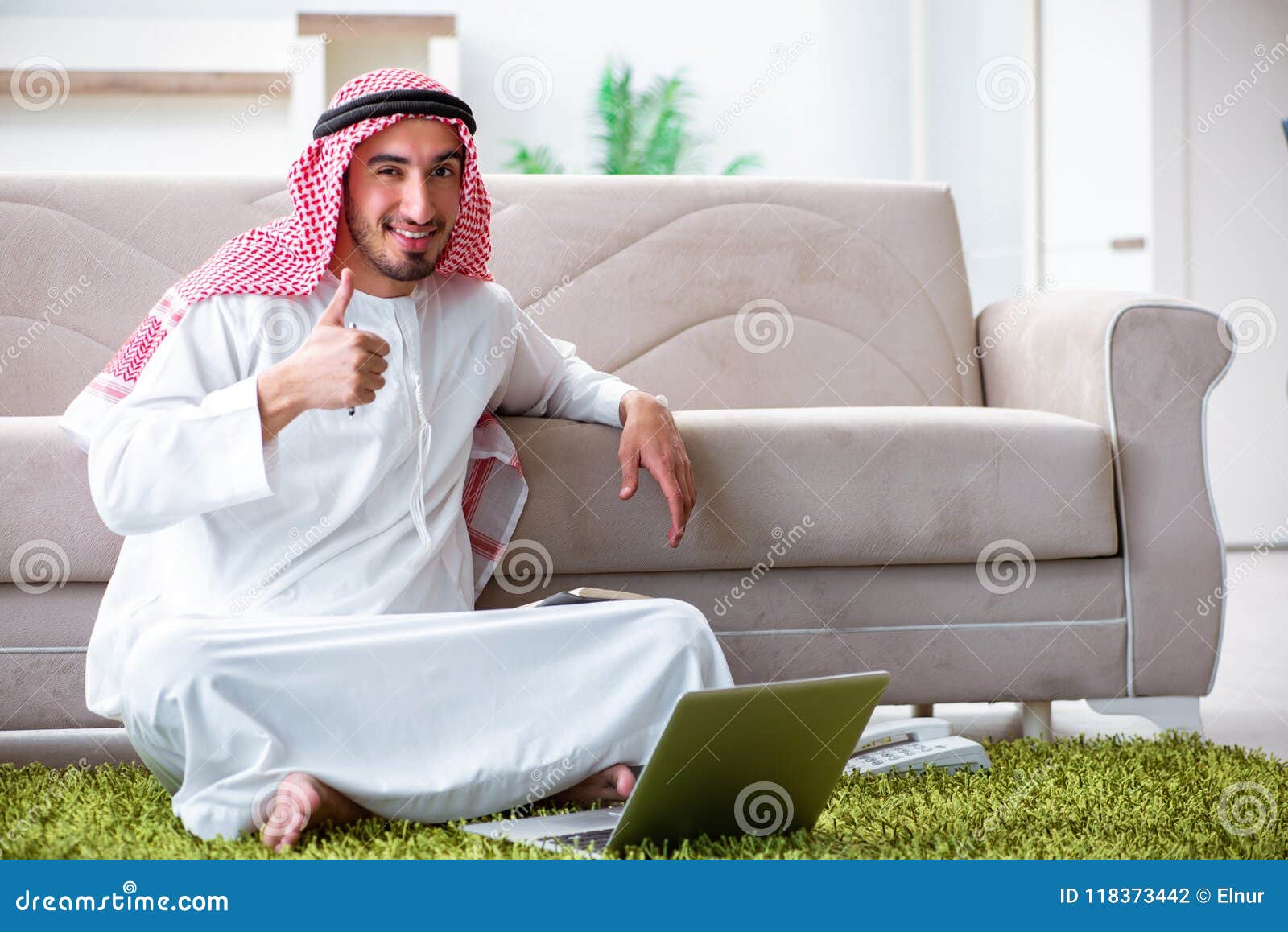 The Arab Man Working at Home on His Work Stock Photo Image of arabic, couch 118373442