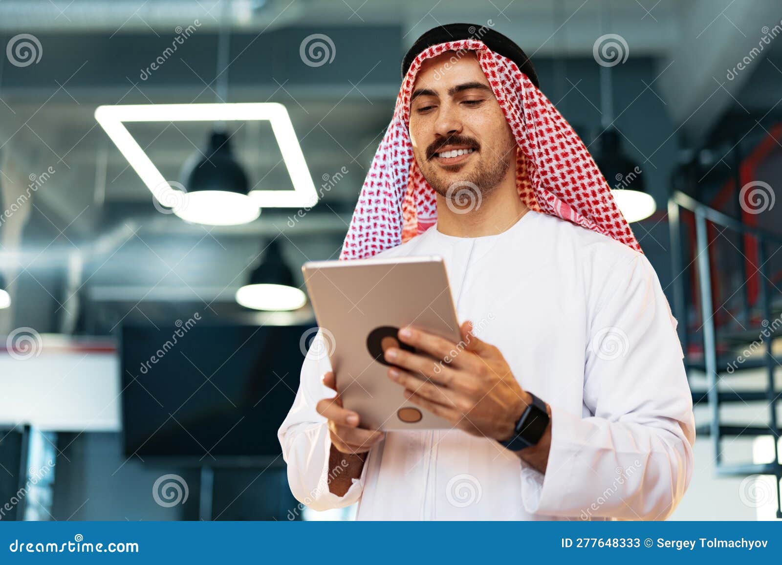 arab muslim businessman using digital tablet in modern office