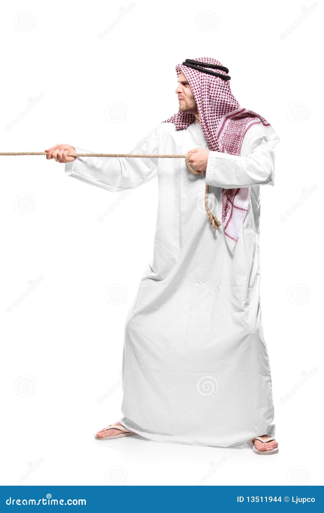An Arab Person Pulling a Rope Stock Photo Image of creed, dress 13511944