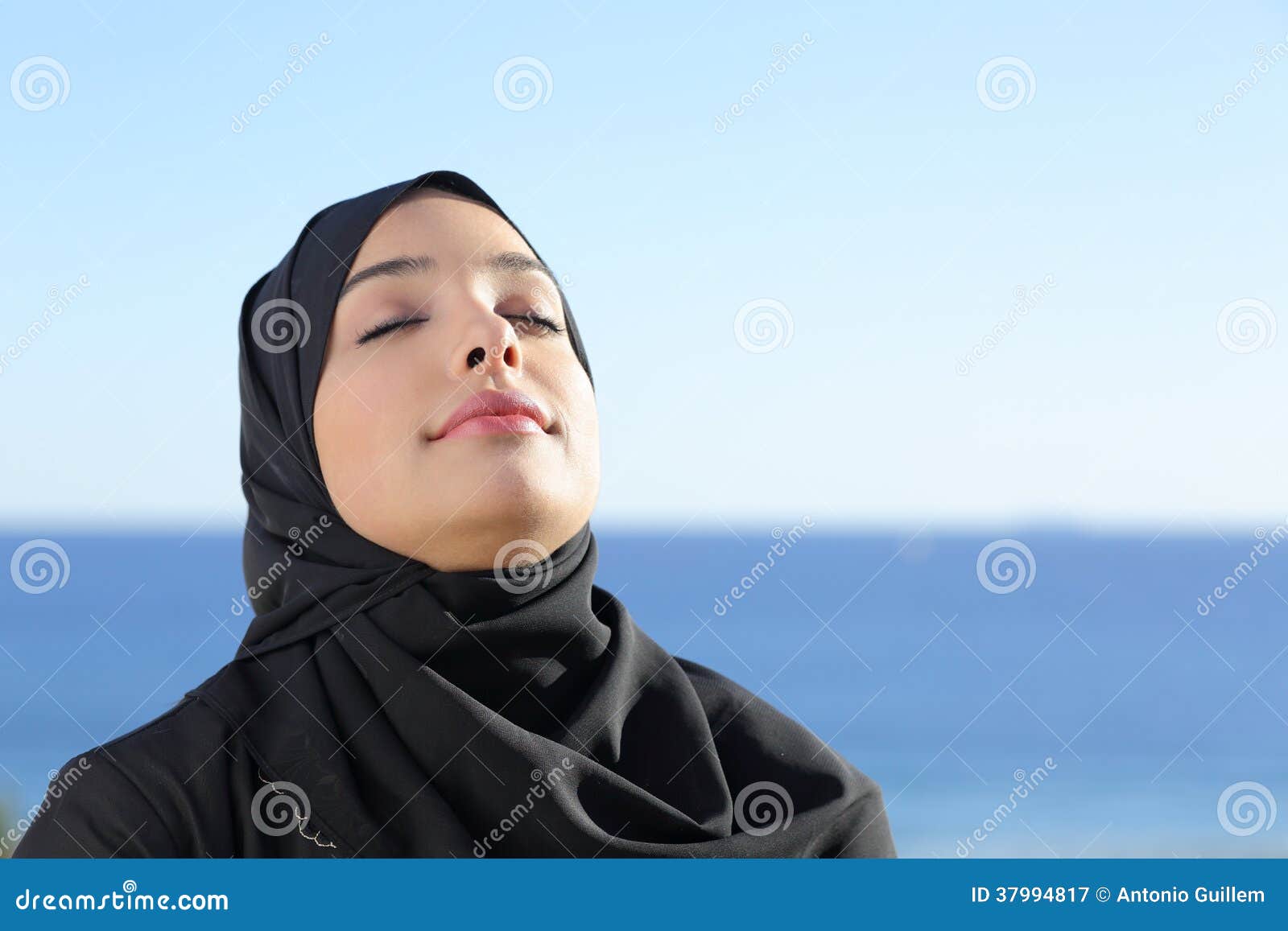 arab saudi woman breathing deep fresh air in the beach