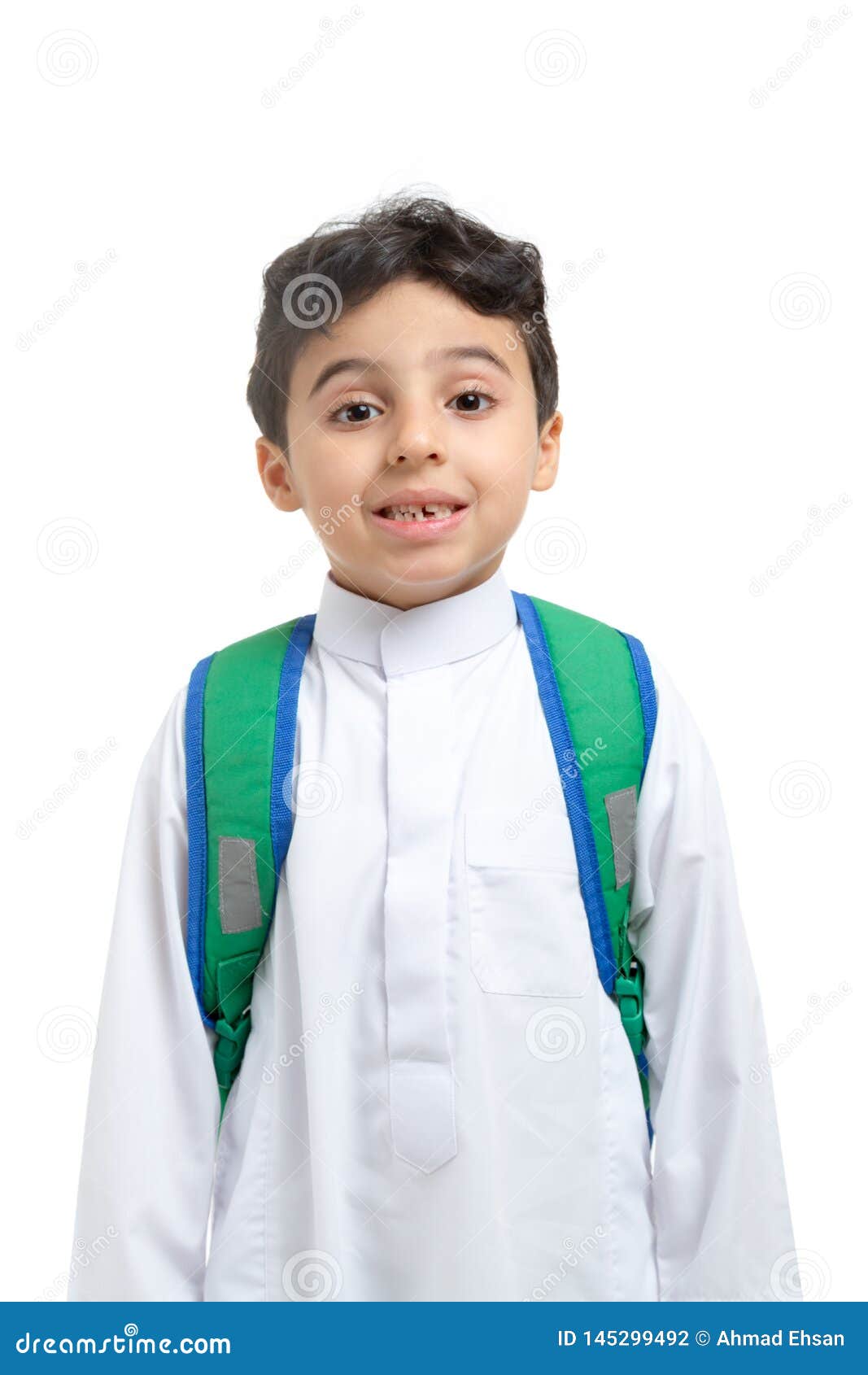 arab school boy closeup on face with a smile and broken tooth, wearing white traditional saudi thobe, back pack and sneakers,