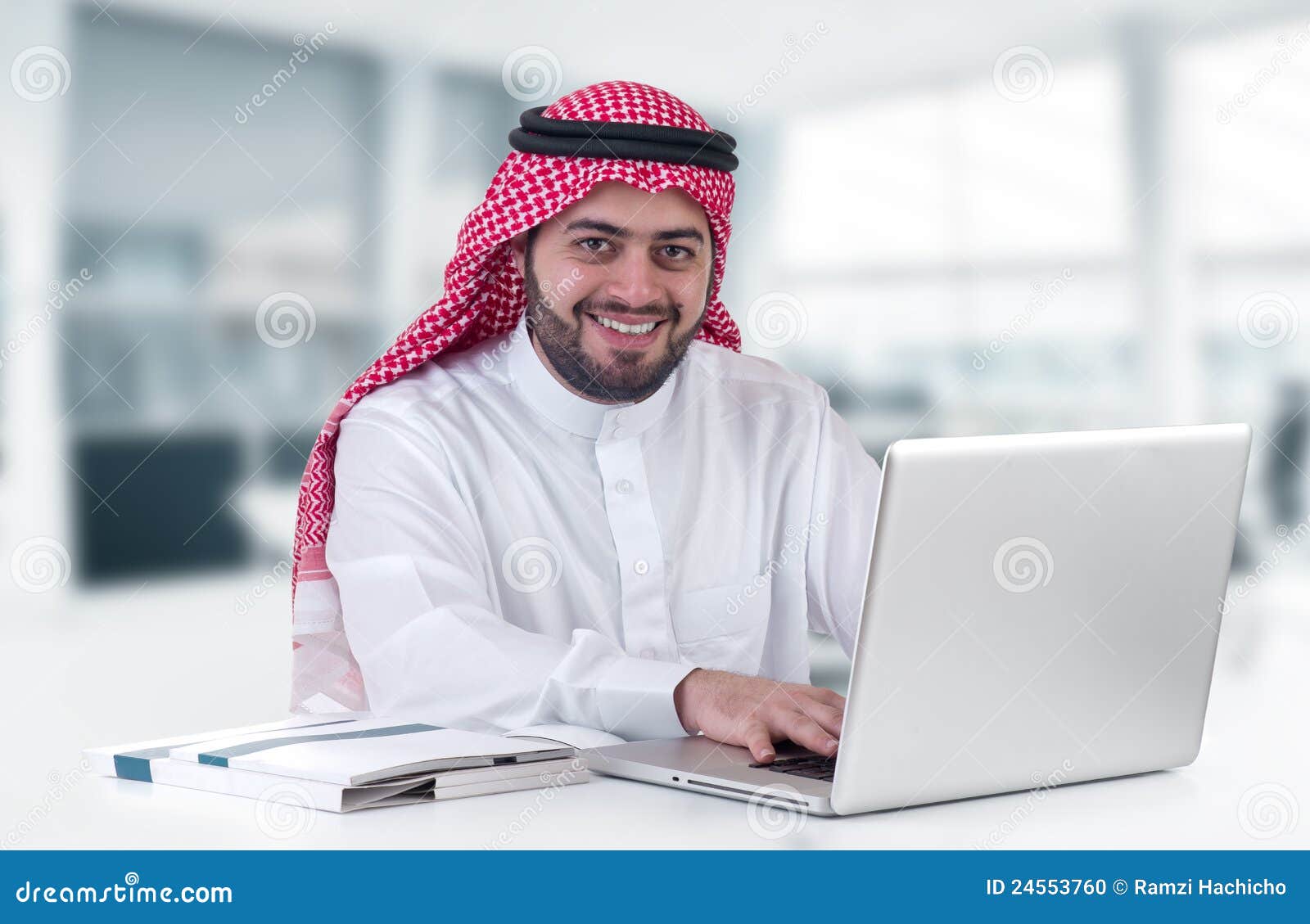 arabian businessman using laptop in office