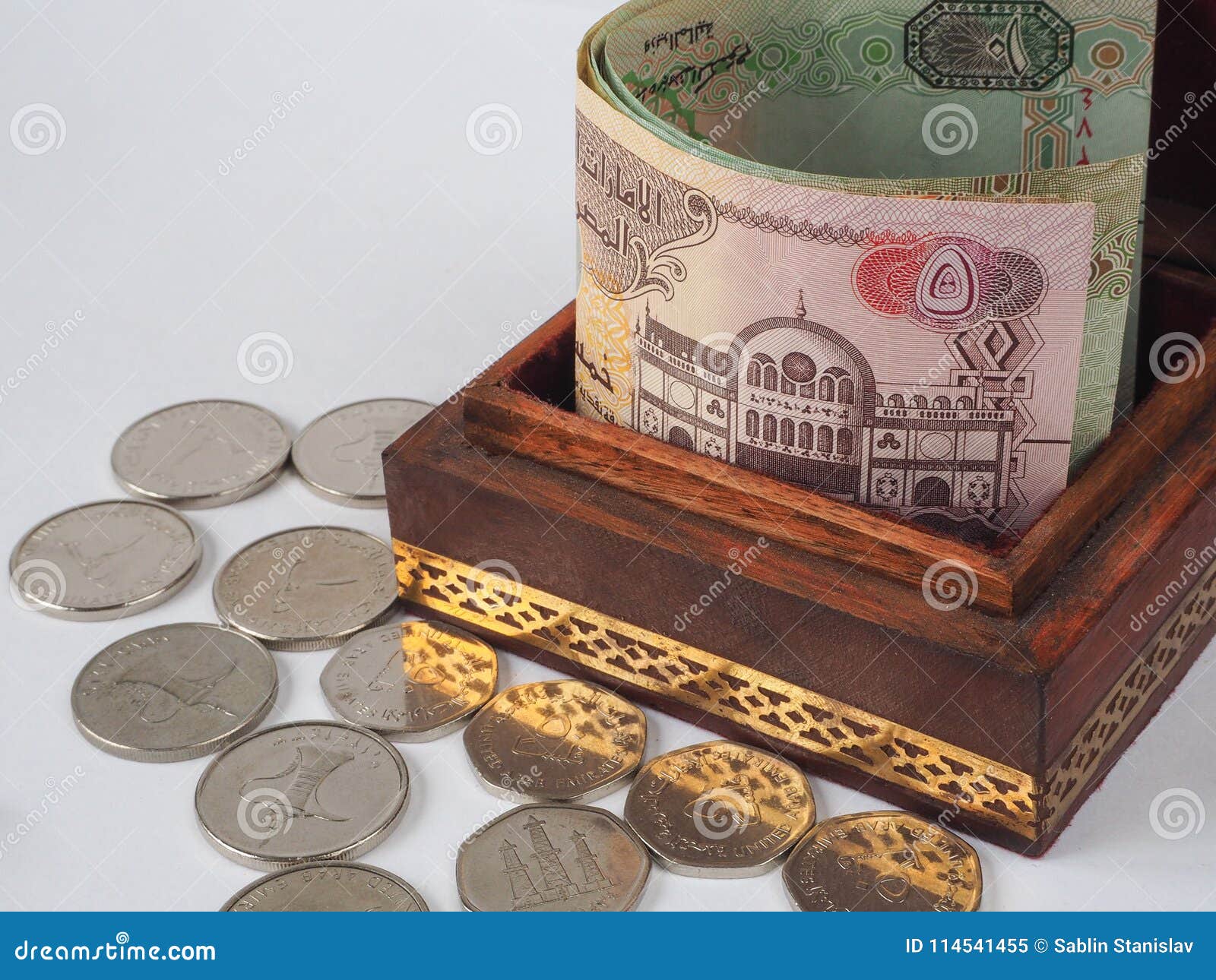 Arabic Coins of Dirhams. Curled Banknotes in His Hands. Stock Image