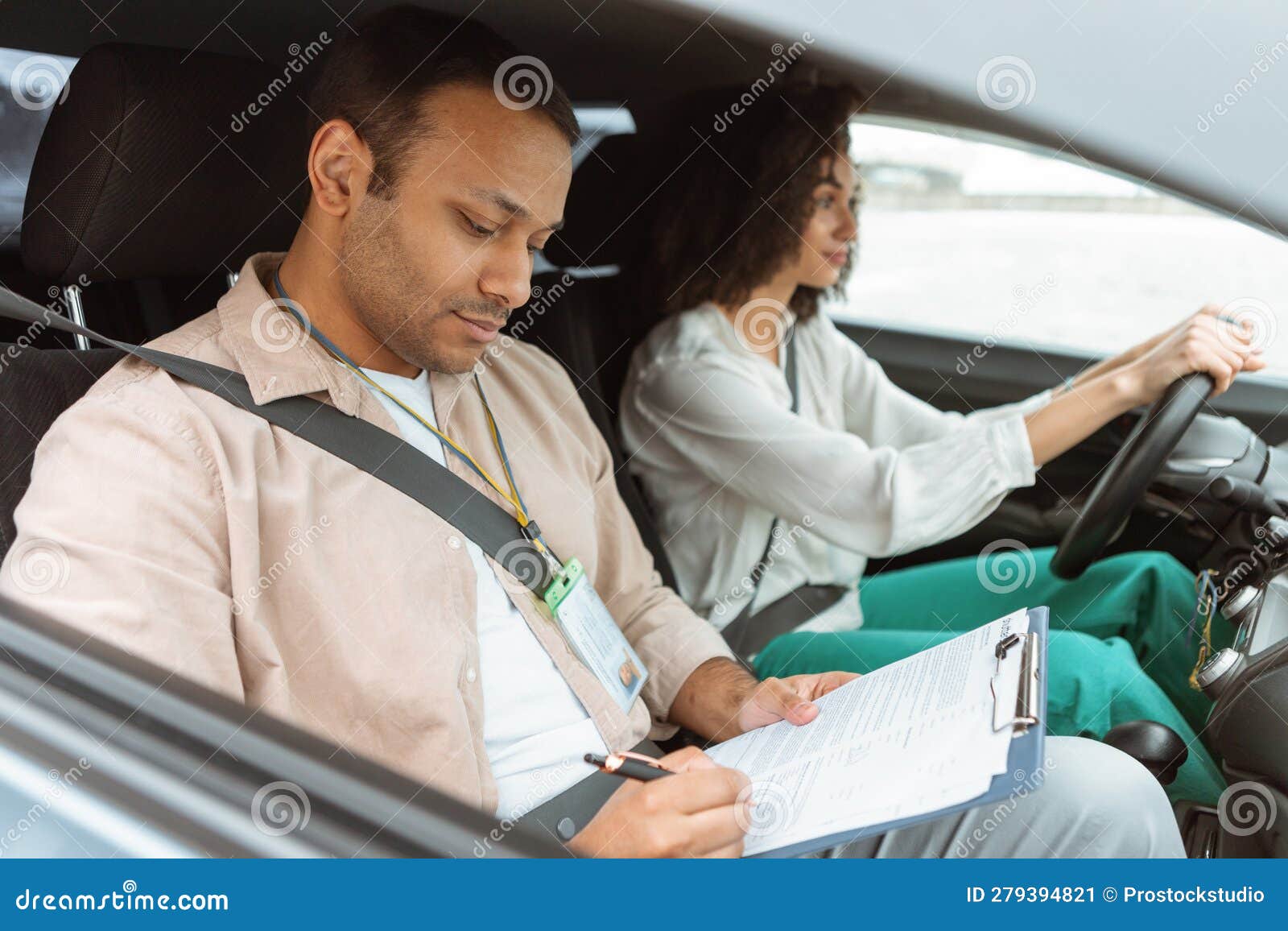 Arabic Instructor Taking Notes Teaching Novice Driver Woman Driving Car