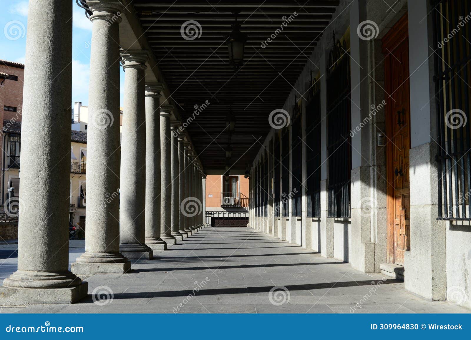 arcades and columns in the plaza de zocodover in toledo, spain.
