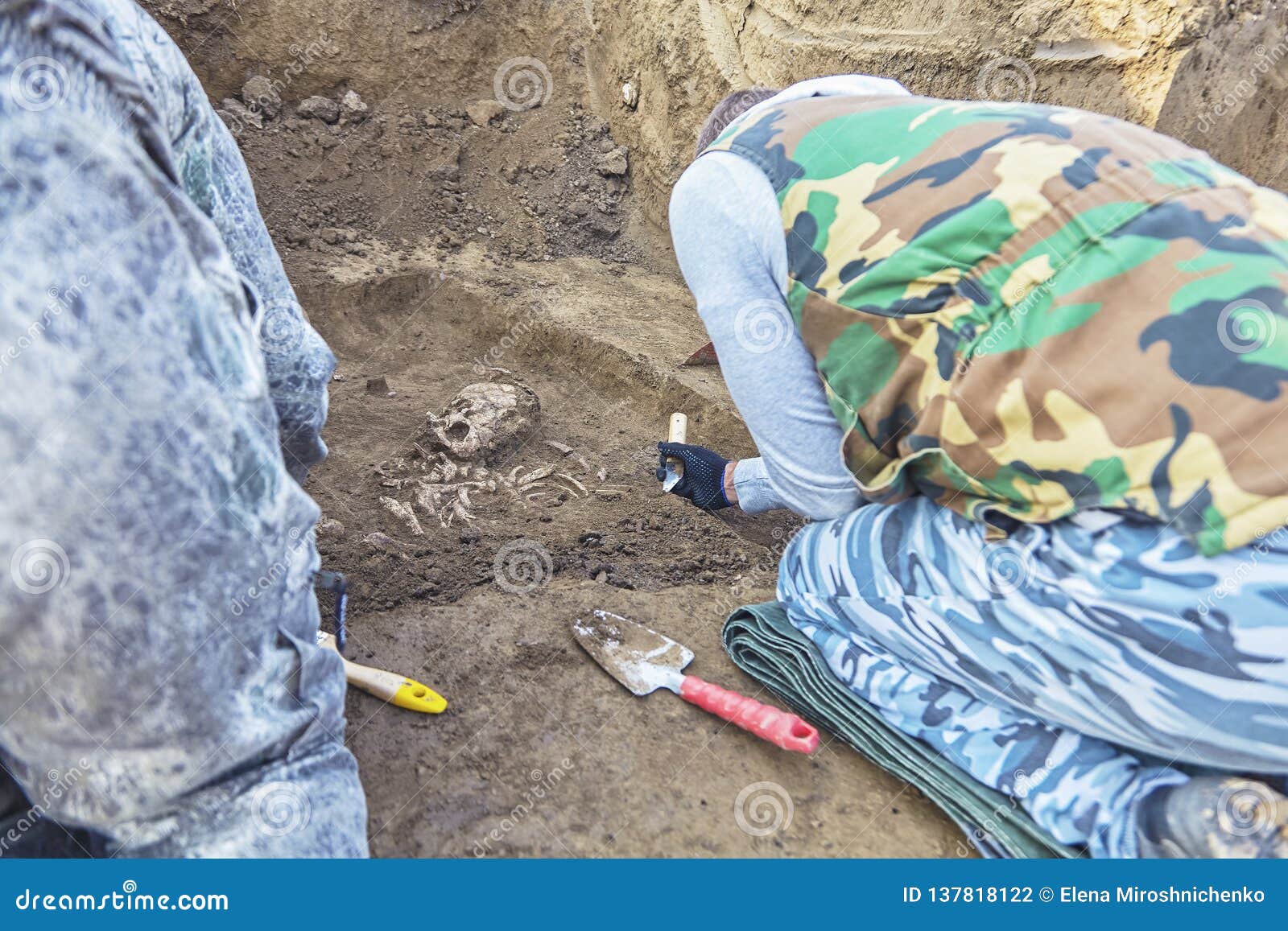 Archaeological Excavations. Two Archaeologists with Tools Conducting
