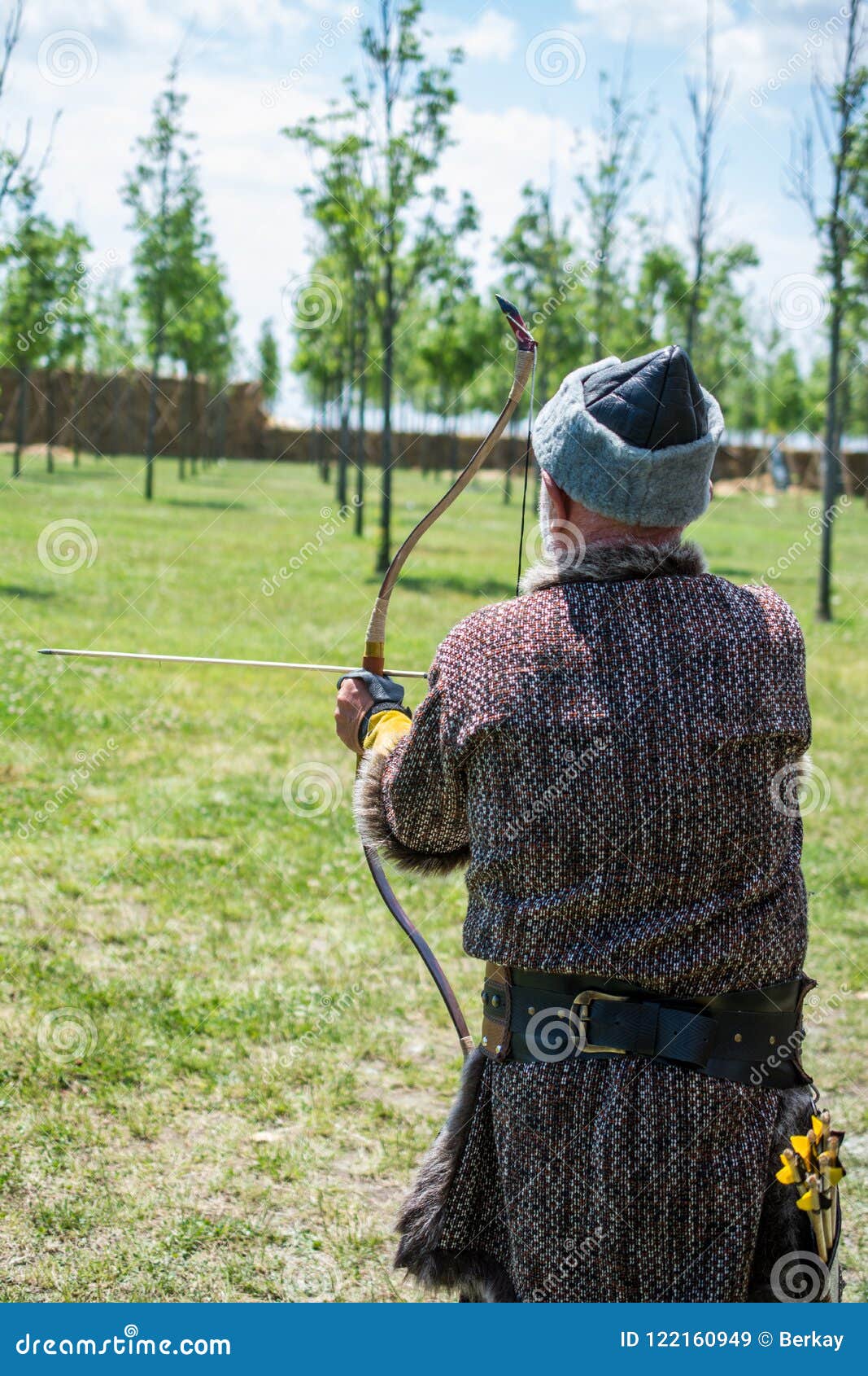 Archer in Traditional Clothes Shooting an Arrow Editorial Stock Image