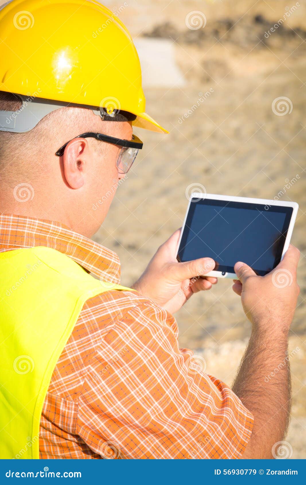 Architect On Building Site Using Digital Tablet on construction site