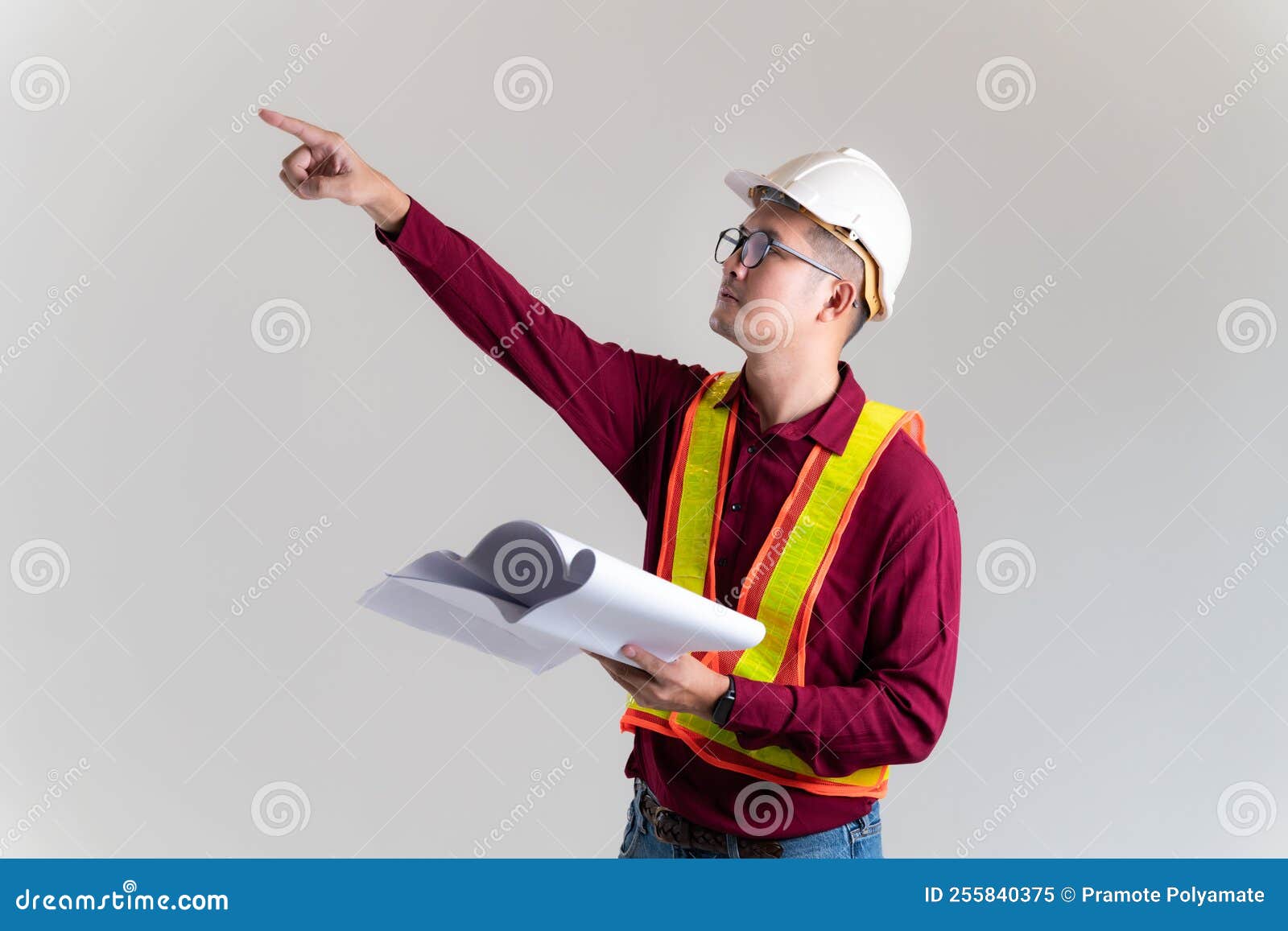 An Architect / Civil Engineer At Work On A Construction Site, Holding