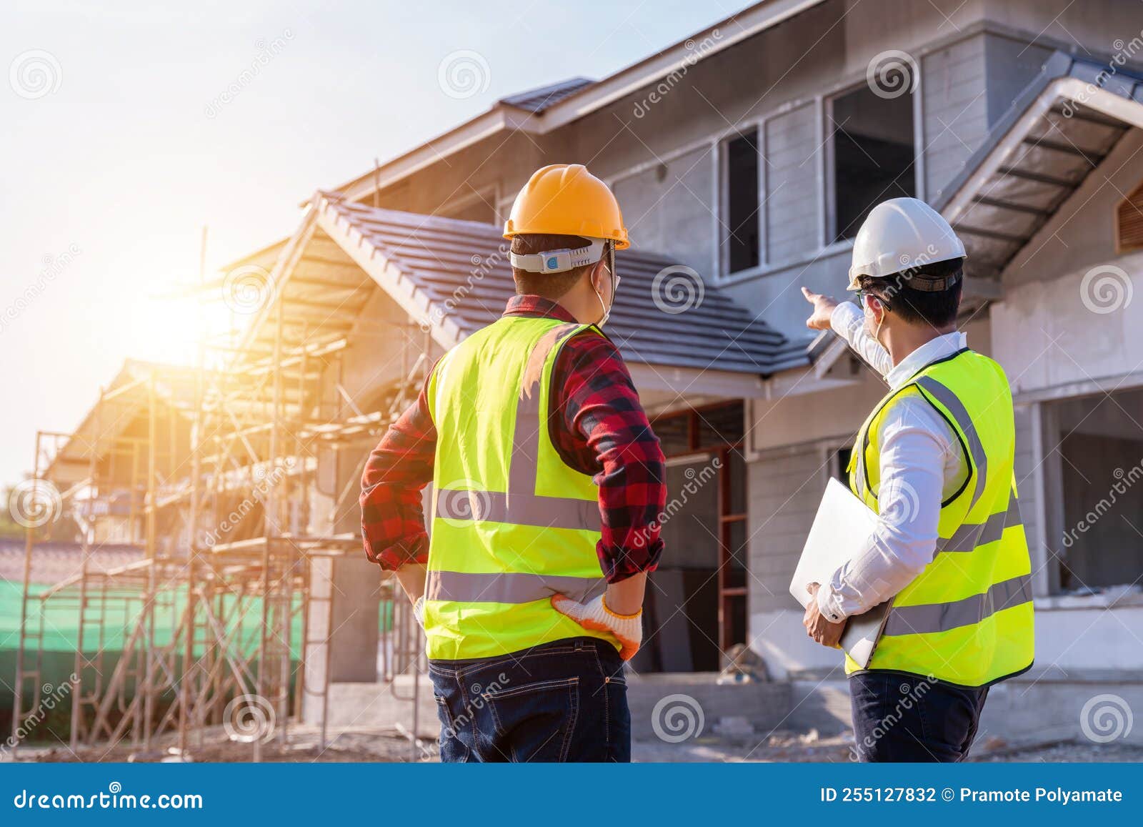 Architect and Engineer Construction Watching Unfinished House at