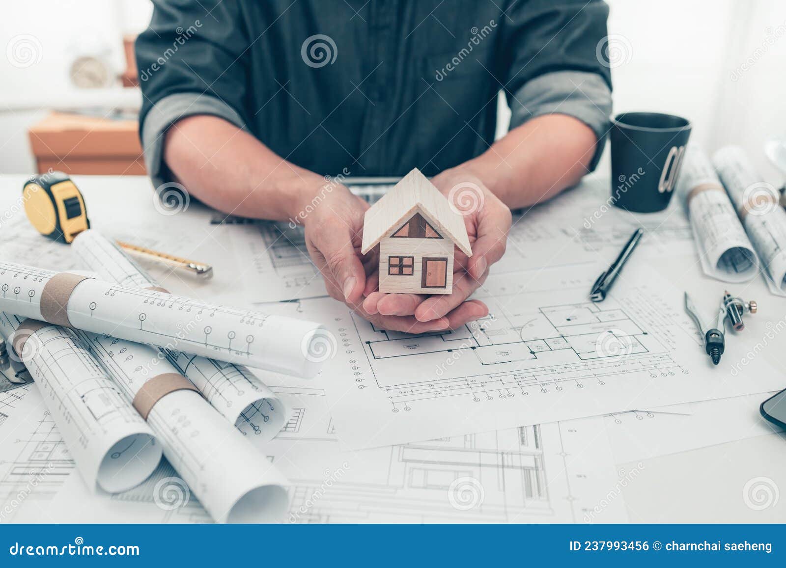 Architect Engineer Hands Hold and Show Mini House Model and Use Pen
