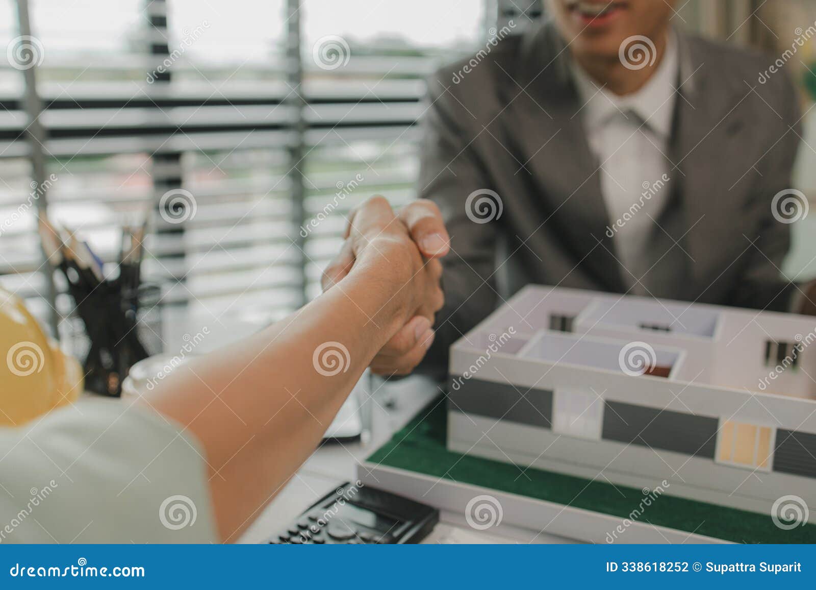 architect and engineer are shaking hand after successfully completing the work, an architect is consulting with an engineer about