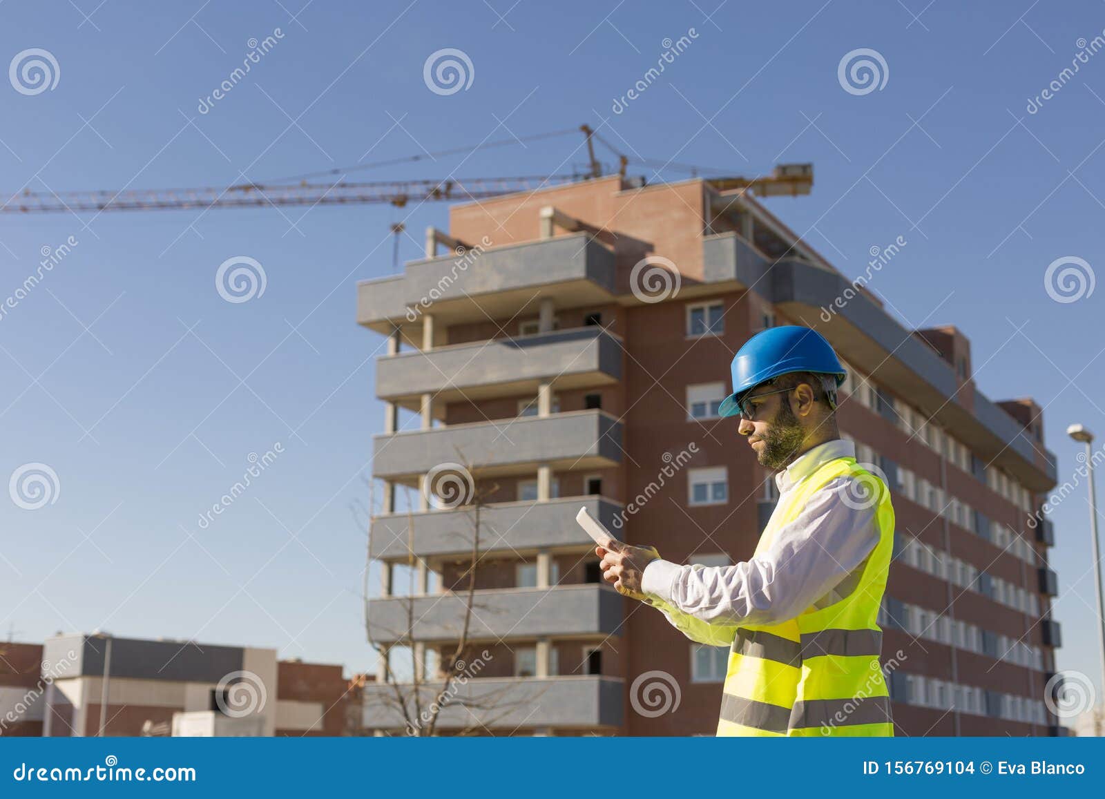 Architect or Engineer Using Tablet on the Construction Site. Hol Stock ...