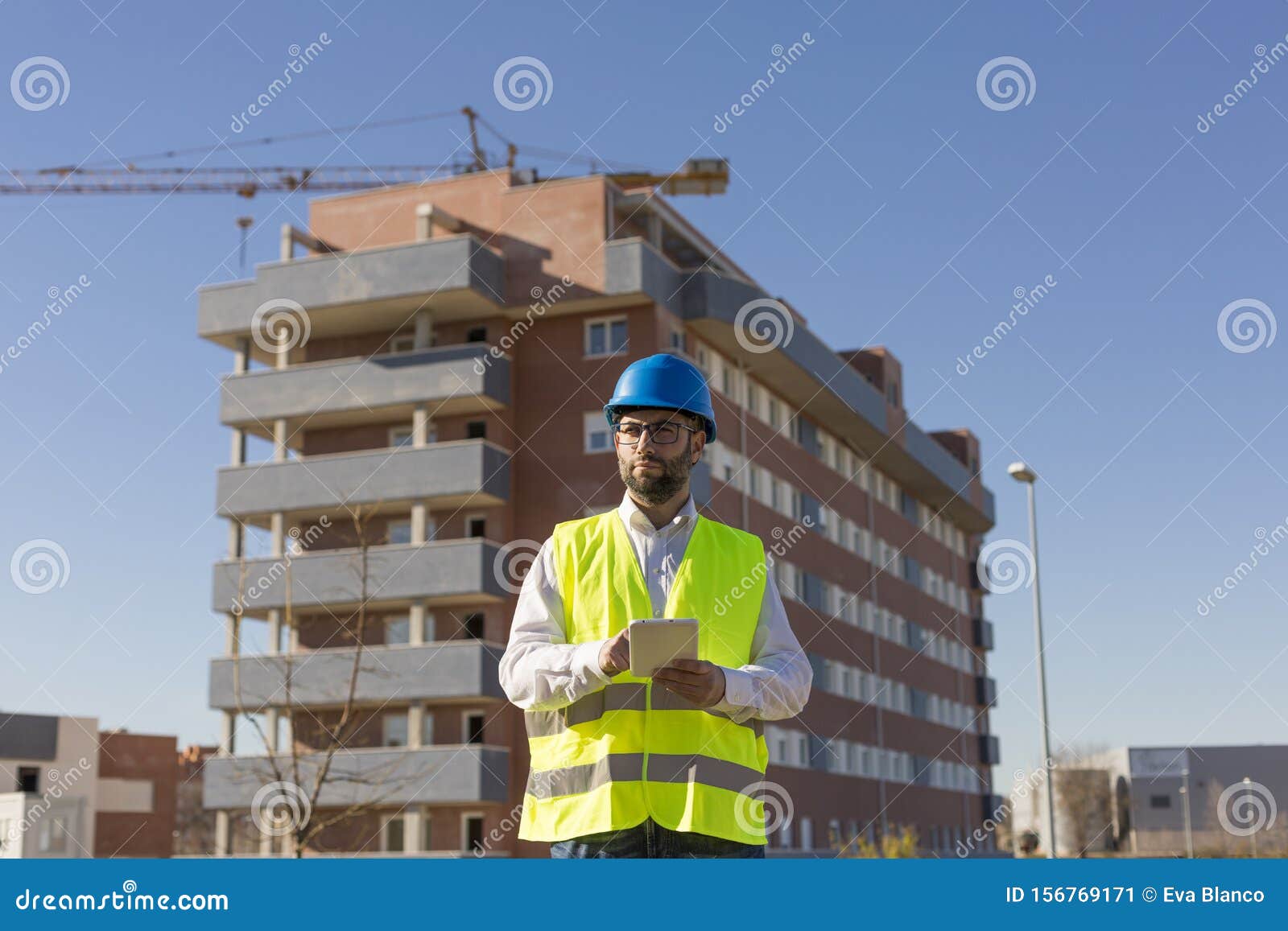 Architect or Engineer Using Tablet on the Construction Site. Hol Stock ...