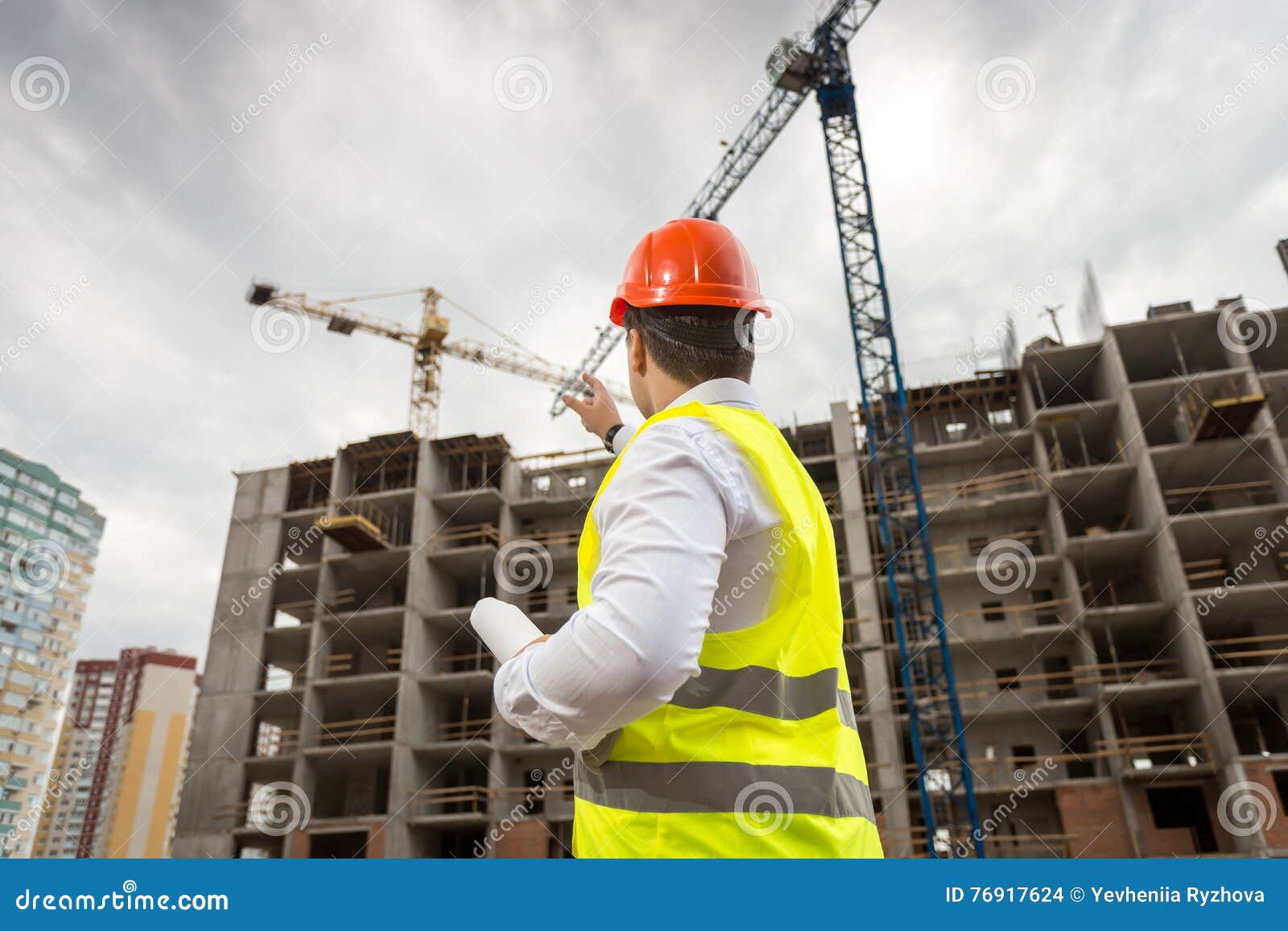 Architect in Hardhat Pointing at Building Under Construction Stock ...