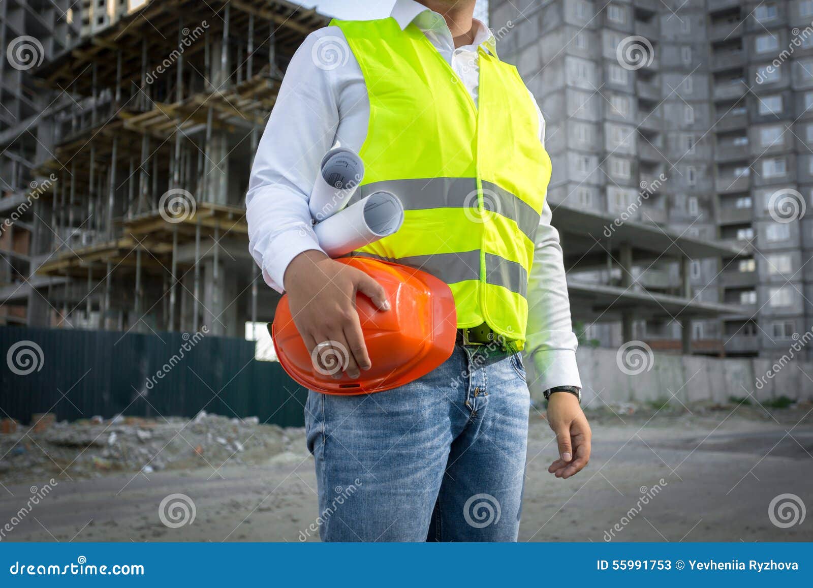 Architect in Jacket Posing with Red Helmet at Construction Site