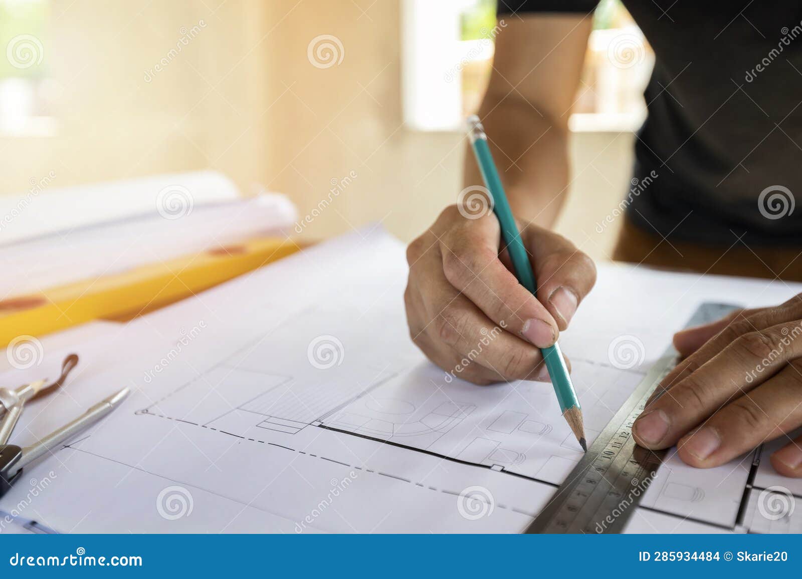 Architect Measuring Scale on Blueprint in Construction Site Stock Photo