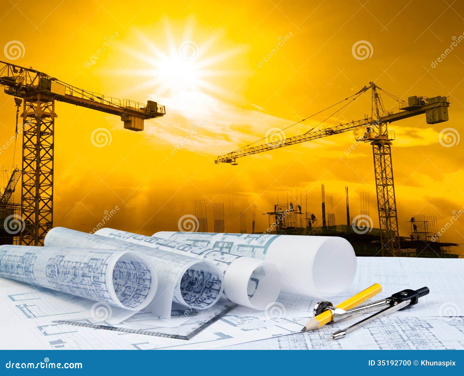 architect plan on working table with crane and building construction background