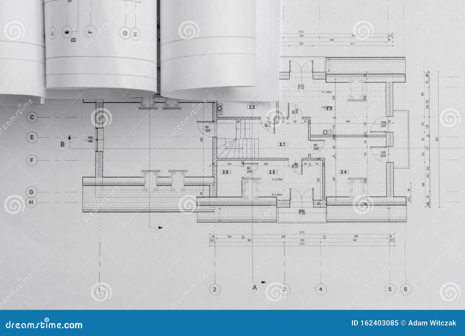 architect rolls and architectural plan,technical project drawing. from above
