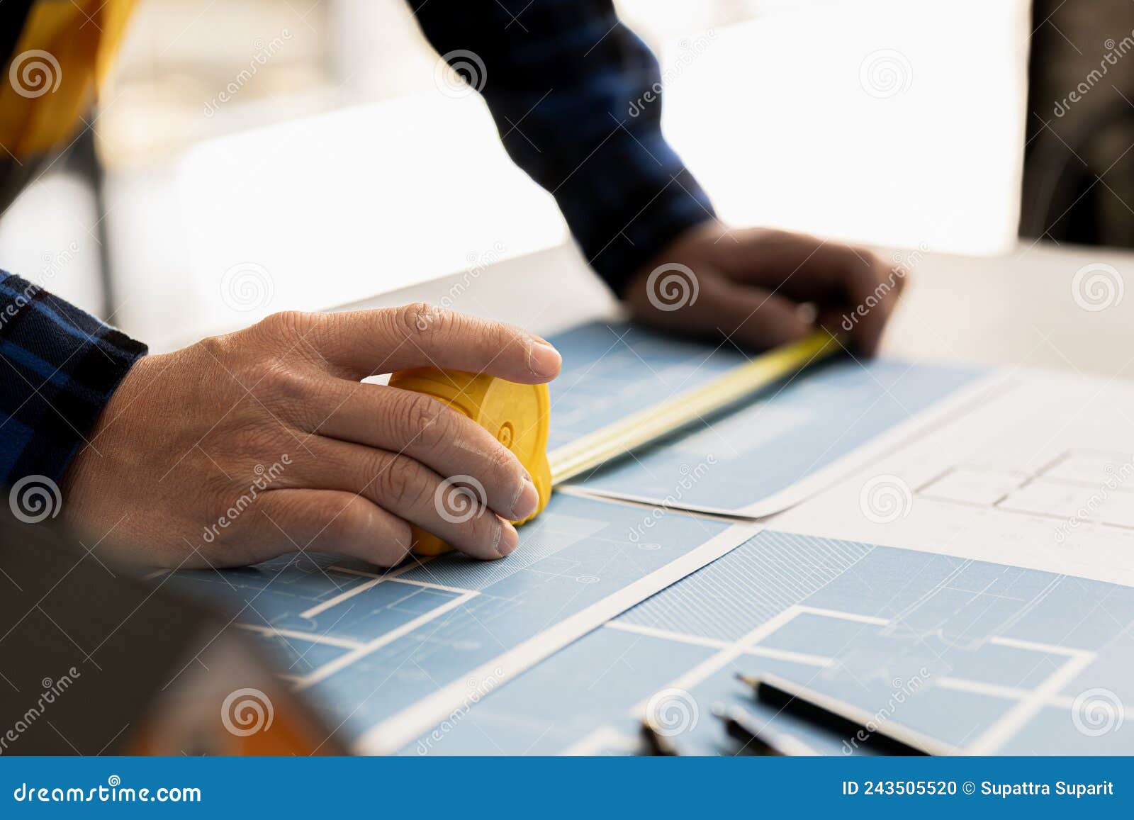 Architects are Using Tape Measure To Measure Building Plans, Architect
