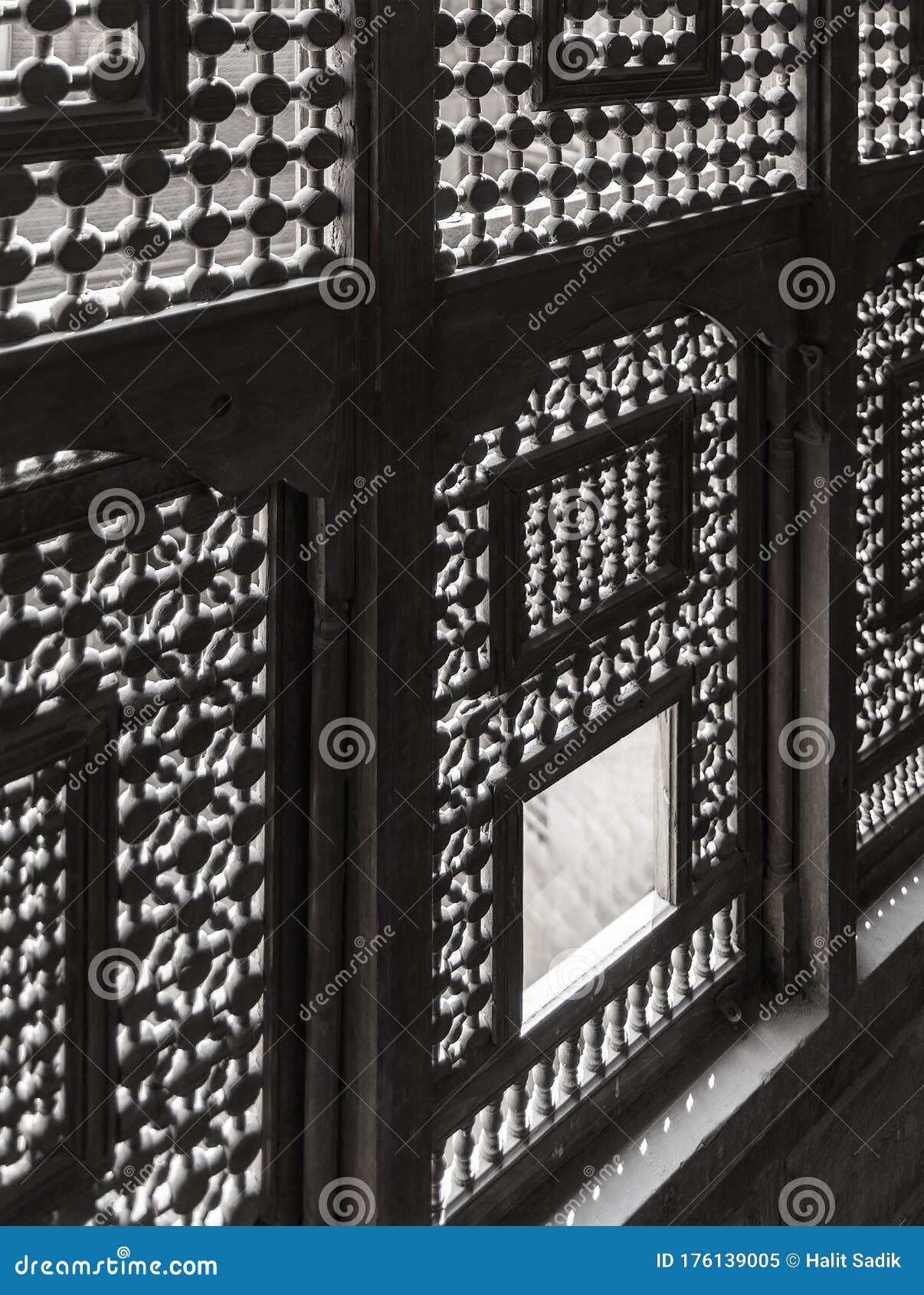 architectural detail of interleaved wooden ornate windows - mashrabiya - at abandoned building