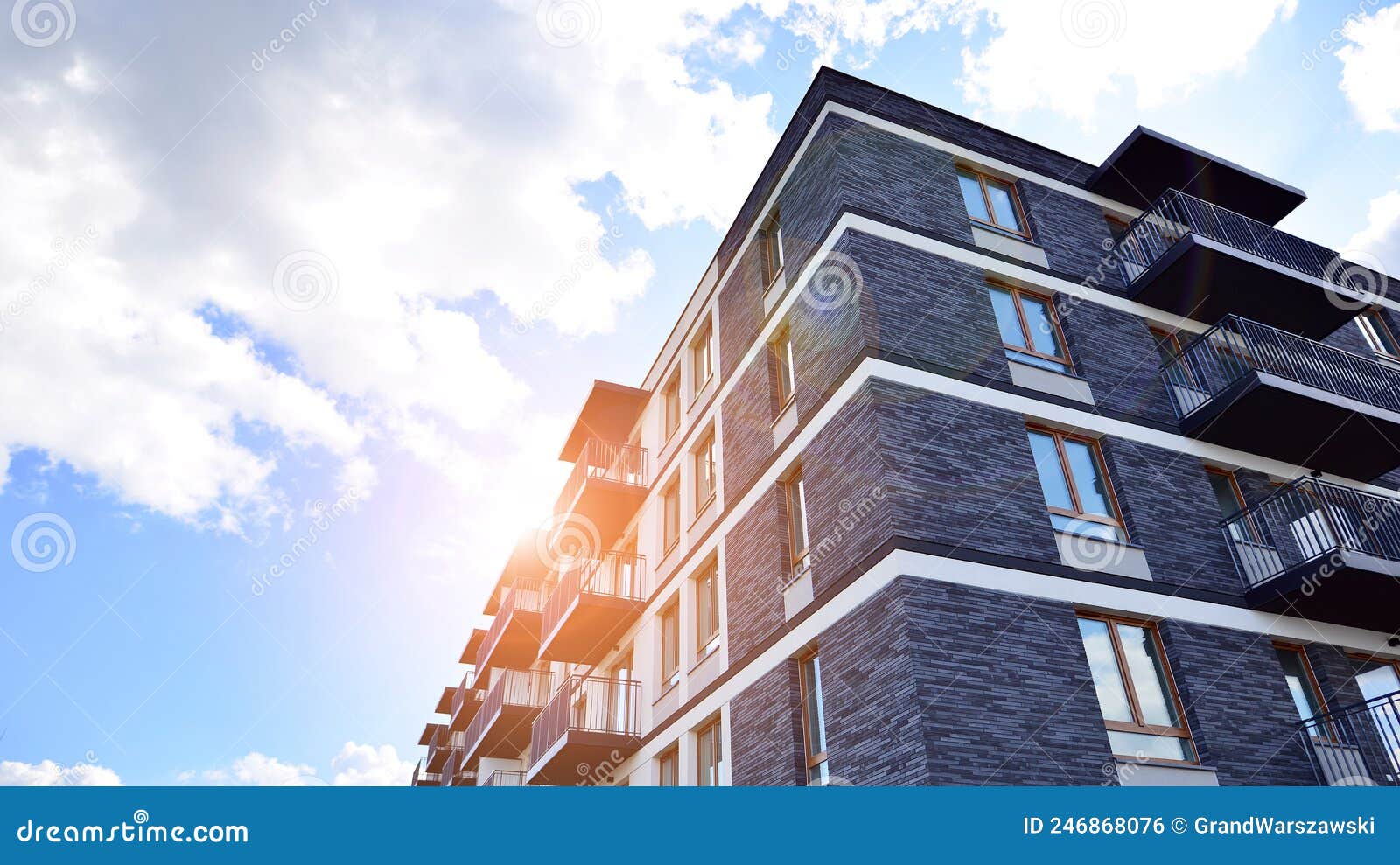 Part of a Residential Building with Balconies and Blue Sky with Clouds