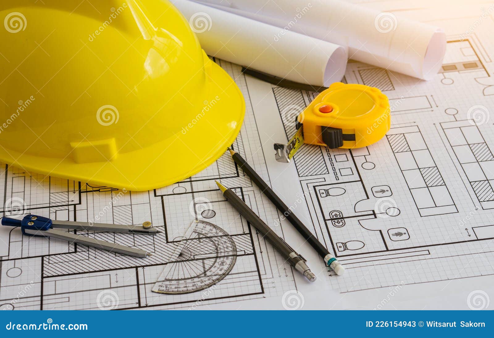 architectural equipment and constuction hat on table