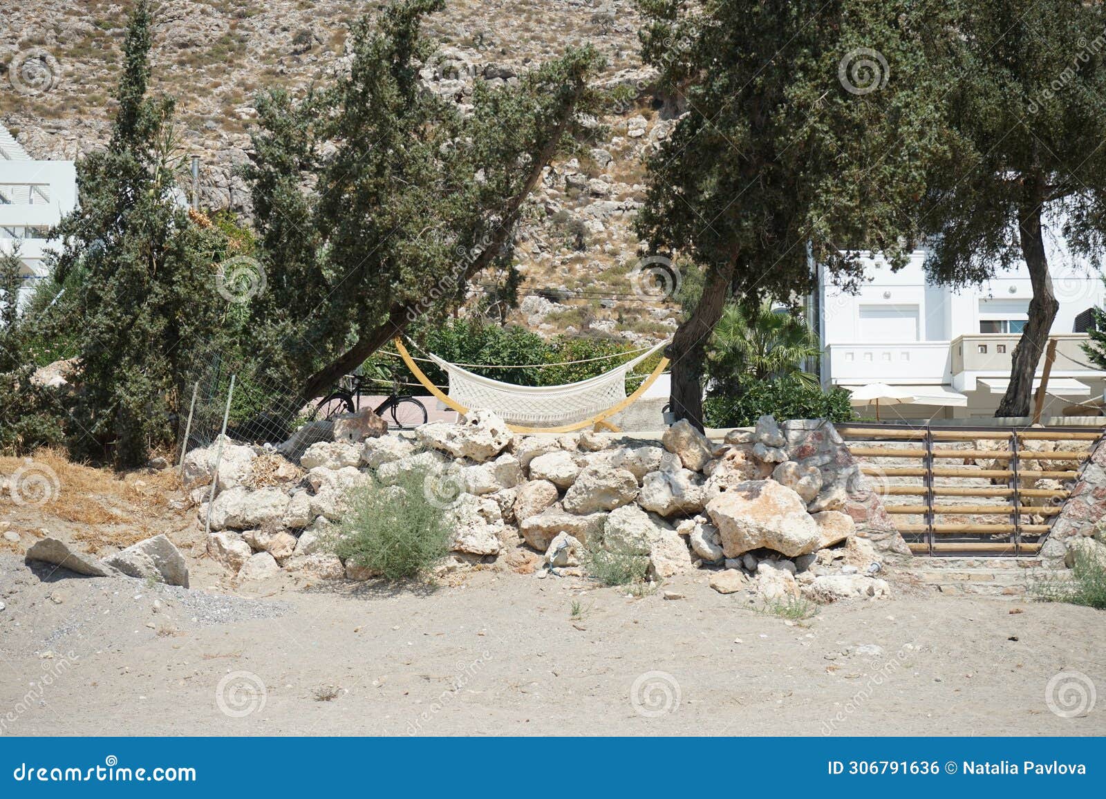 a hammock hangs between the trees. pefki, rhodes island, greece