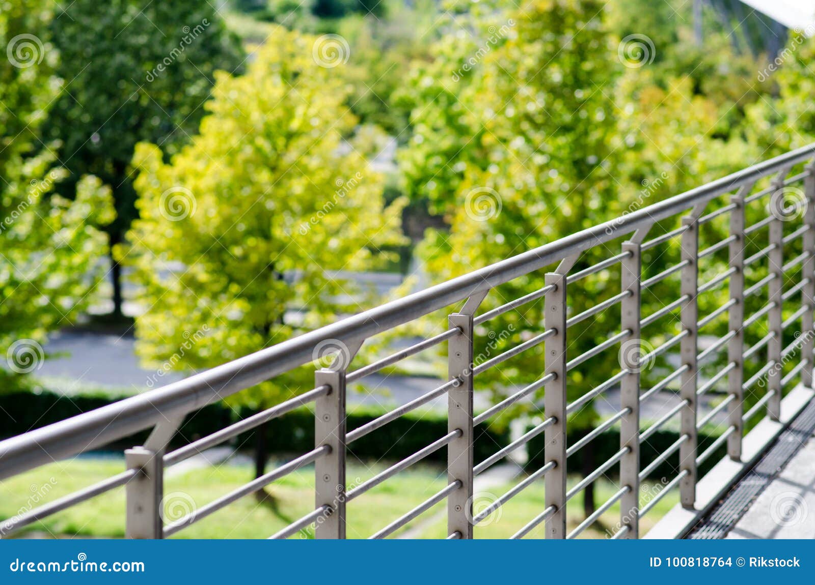 architecture, railing on tree-lined park.